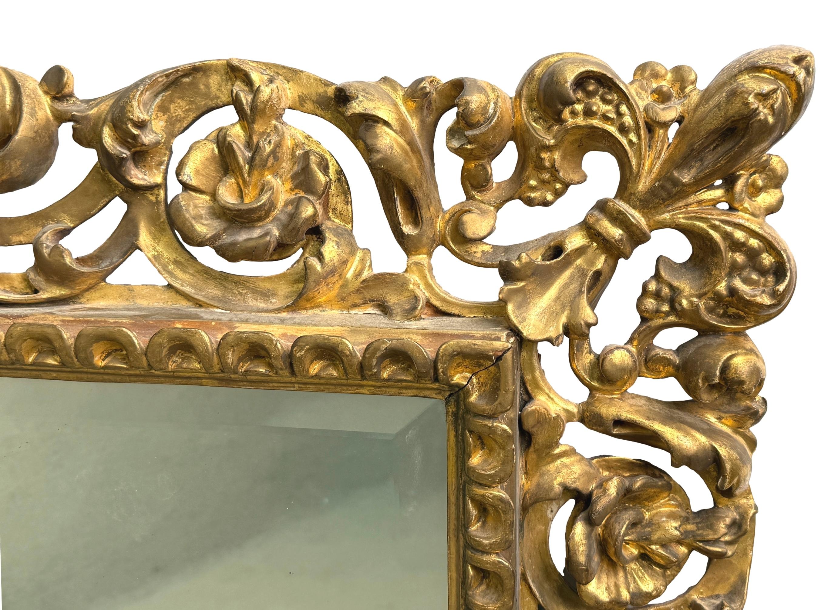 An Extremely Attractive 19th Century Florentine Design Italian Giltwood Wall Mirror, Having Superb Carved Frame With Central Shells, Intertwined Floral Trails And Giglio Corners, All Enclosing Rectangular Old Bevelled Mirror Plate With Replacement
