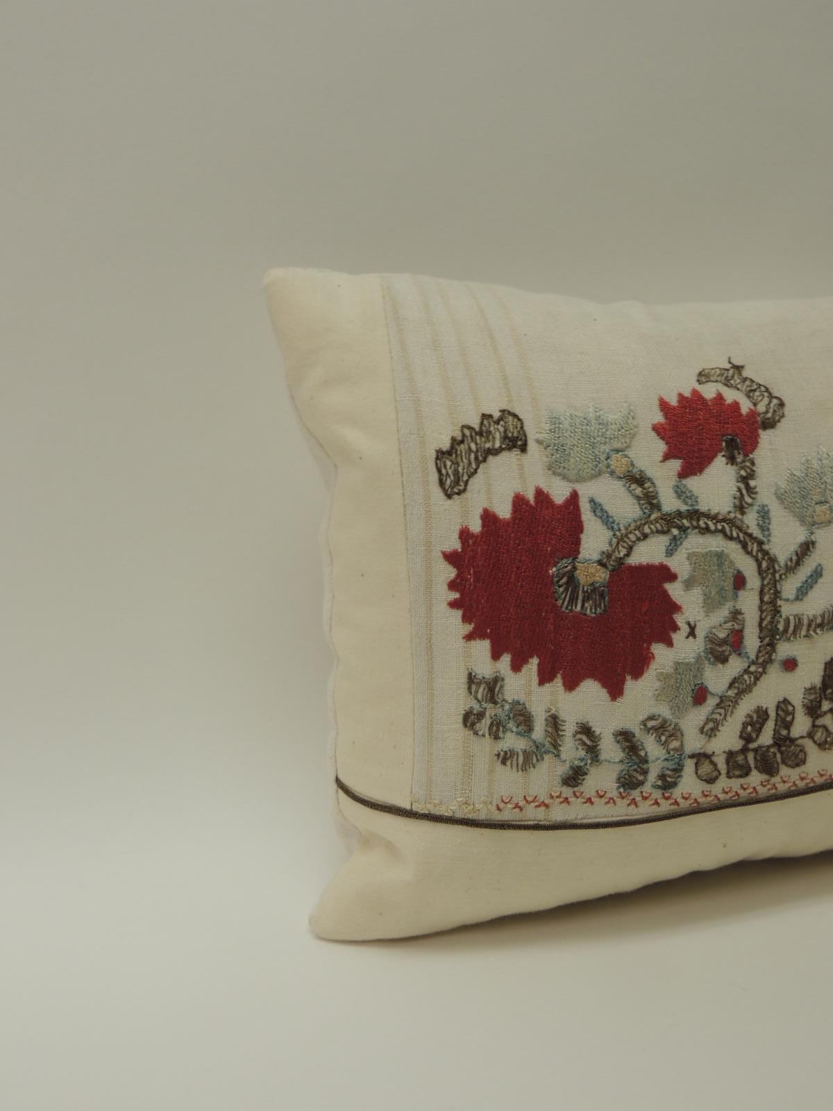 19th century Turkish embroidery lumbar pillow.
Turkish linen and silk embroidery lumbar pillow. Depicting flowers and trees, decorative gold trim across the linen frame. Natural antique linen backing. In shades of red, green, silver metallic