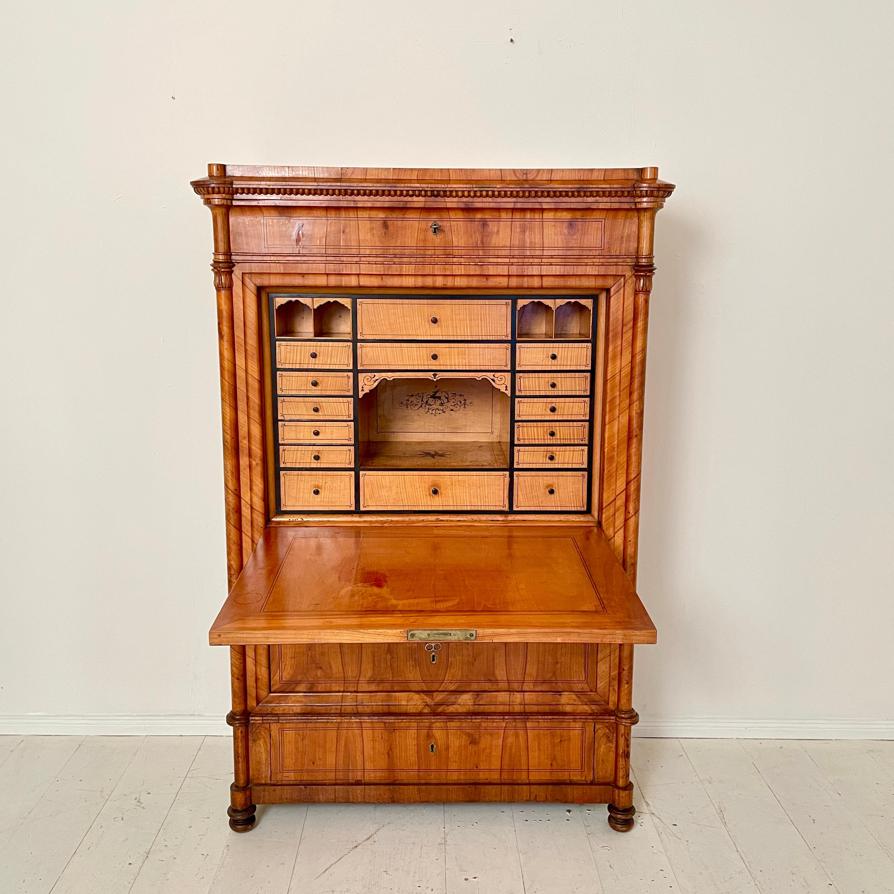 This beautiful 19th century Biedermeier Secretary is made out of Pine and veneered in Cherry wood. The inside is veneered in maple and solid maple. It was made around 1835 in South Germany.

A unique piece which is a great eye-catcher for your