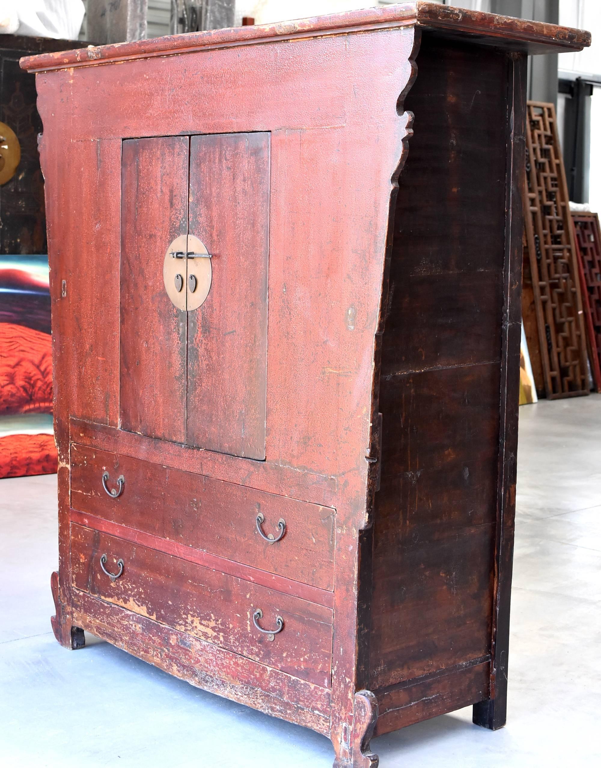 A beautiful antique red crackle cabinet from Shan Xi Province. The style is very unique yet distinctive of the Northern Chinese region. Such a vernacular design is reflected in the following areas: thicker frame works are used in structure, heavier