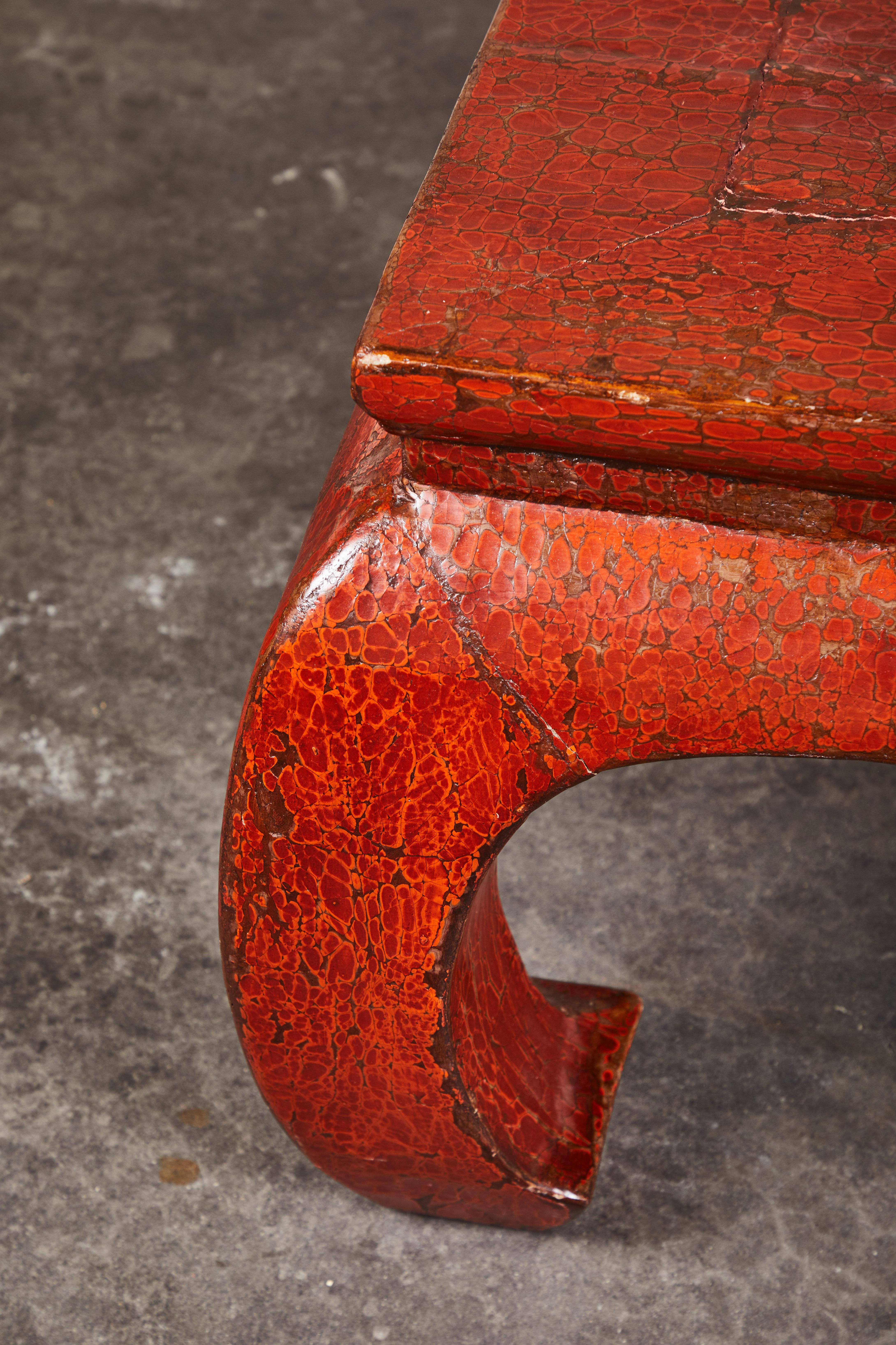 A 19th century red lacquer kang table. Recently refreshed, but original crackled red lacquer finish. Smaller size makes this table functional in smaller living spaces. Slightly rectangular overall shape, timeless antique design.