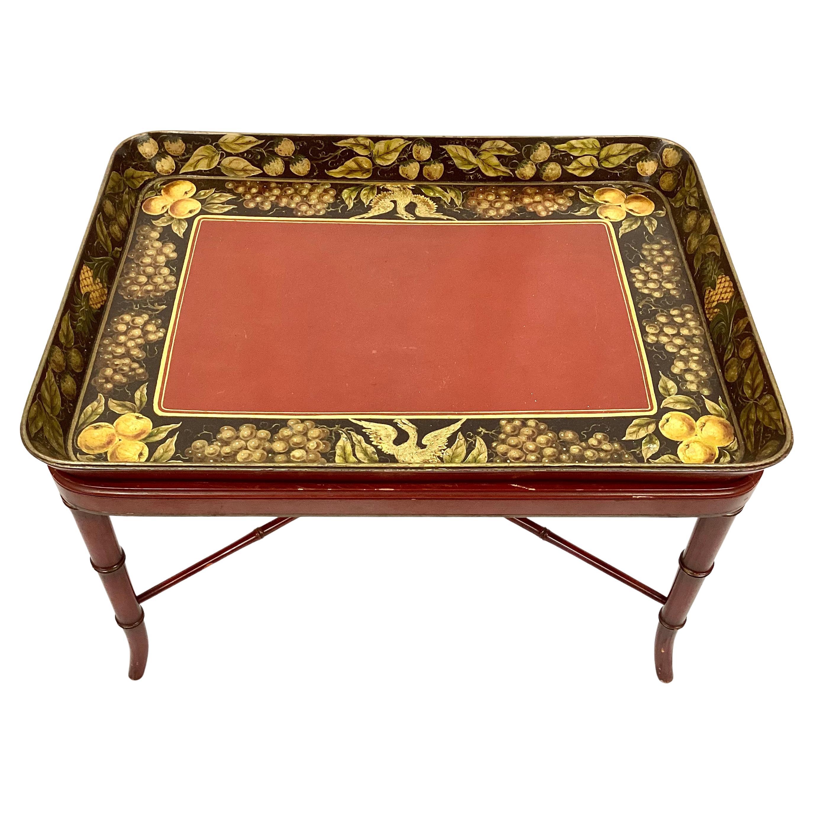 Antique English tray table with lacquered red, gold and black colors of a fruit, leaves and bird motif. Stand is red faux bamboo. Tray is removable and bamboo table and tray can be used separately.