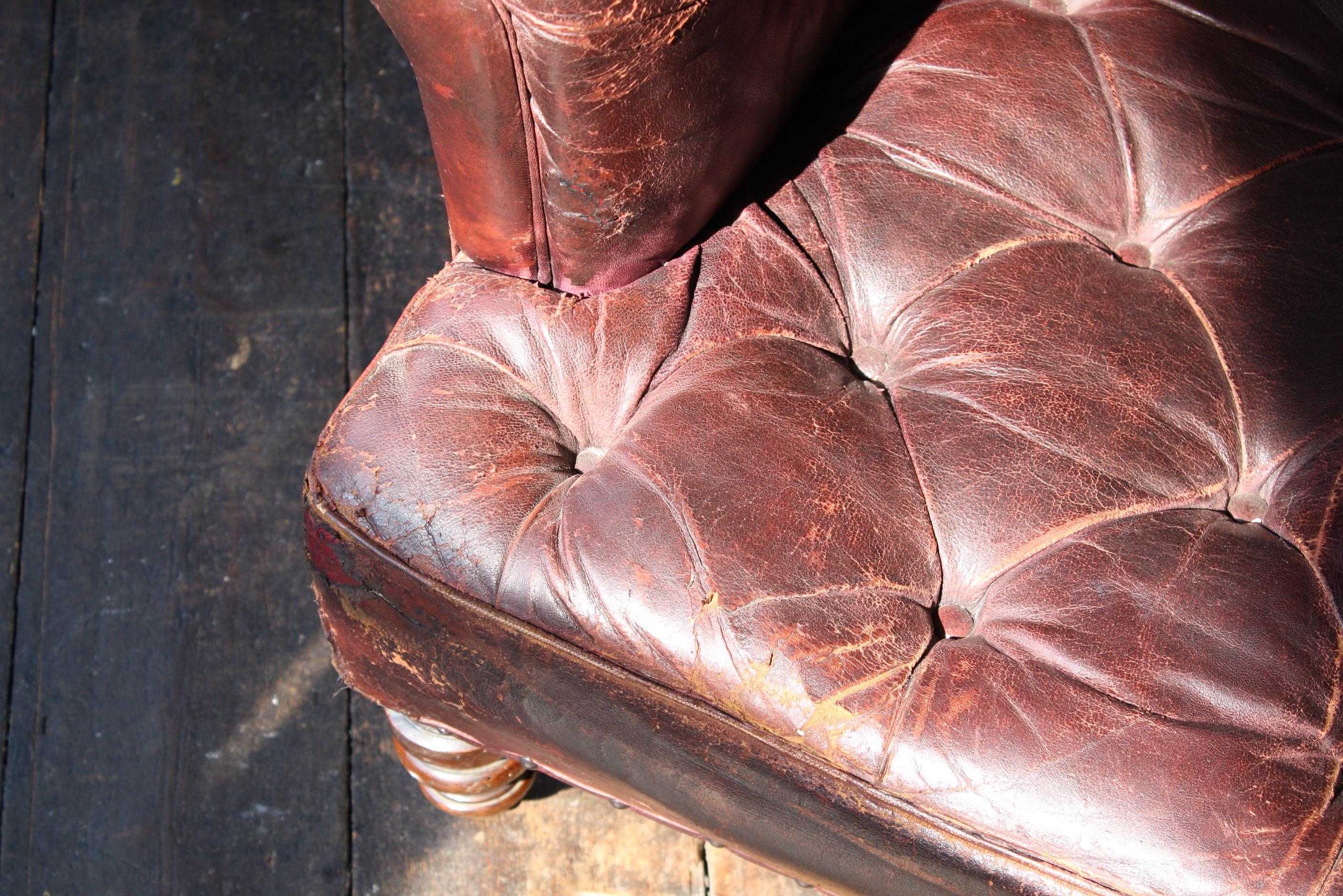 A fine and original late 19th century maroon buttoned leather armchair.

On turned front legs and typical squared back, all with their original brass castors. 

Areas of wear as you would expect, some minor tears on the exterior side panels with