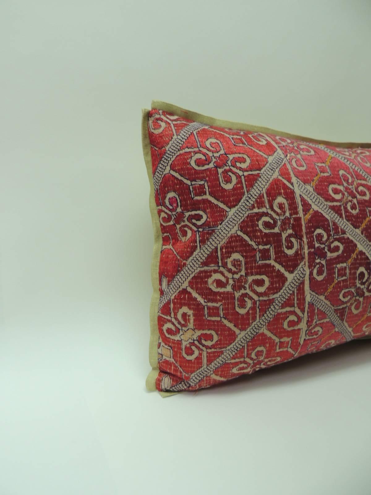 Large 19th century Moroccan embroidered bolster pillows with traditional floral design, floss silk threads in shades of red and green in a chevron pattern. Golden silk  backing same as custom ATG silk golden flat trim.  Decorative pillows hand-made