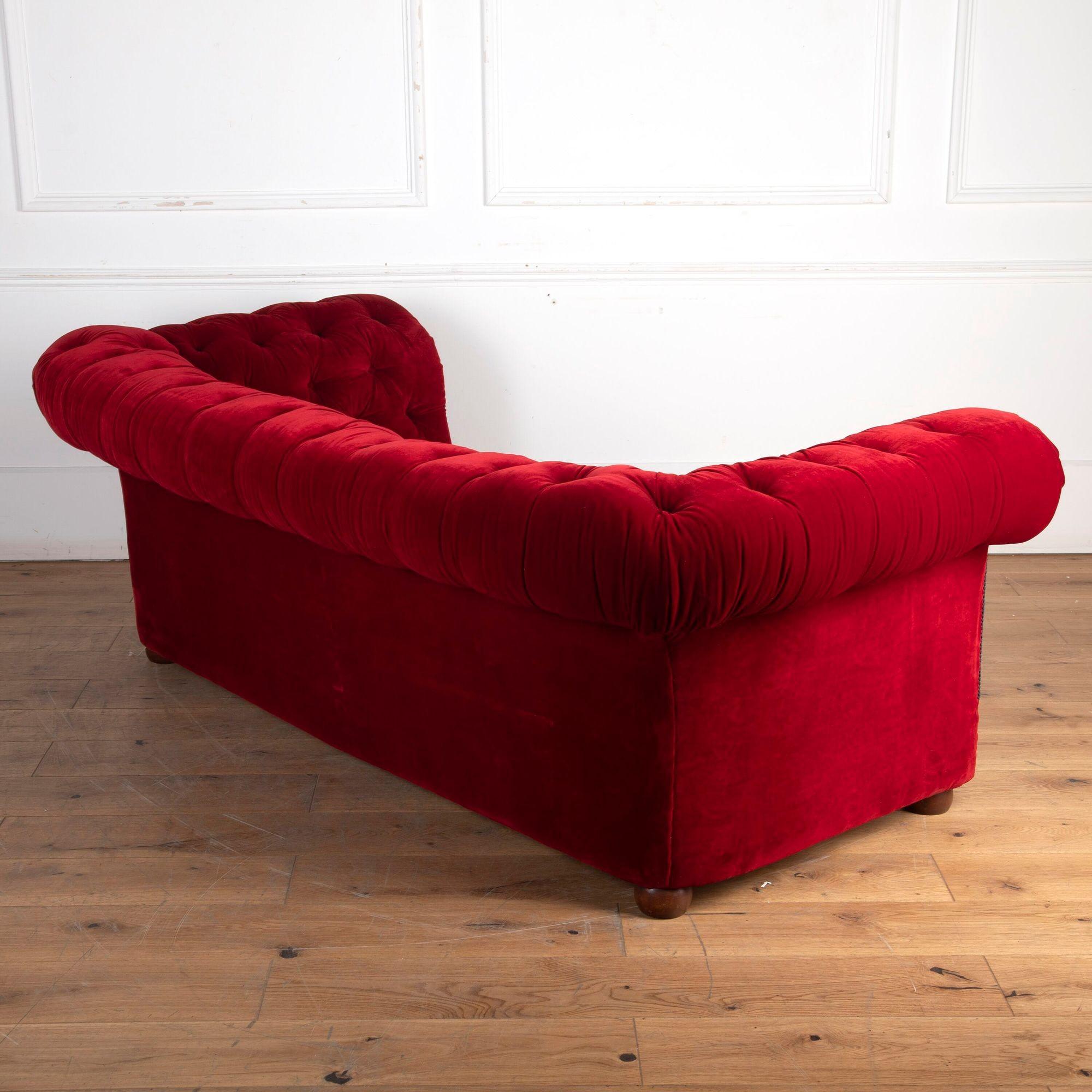 Stunning 19th Century drop-end buttoned red Chesterfield sofa.
Still retaining its original Victorian red velvet fabric which is in remarkable condition for its age.
Within today's home, this would make for a striking addition to any setting!