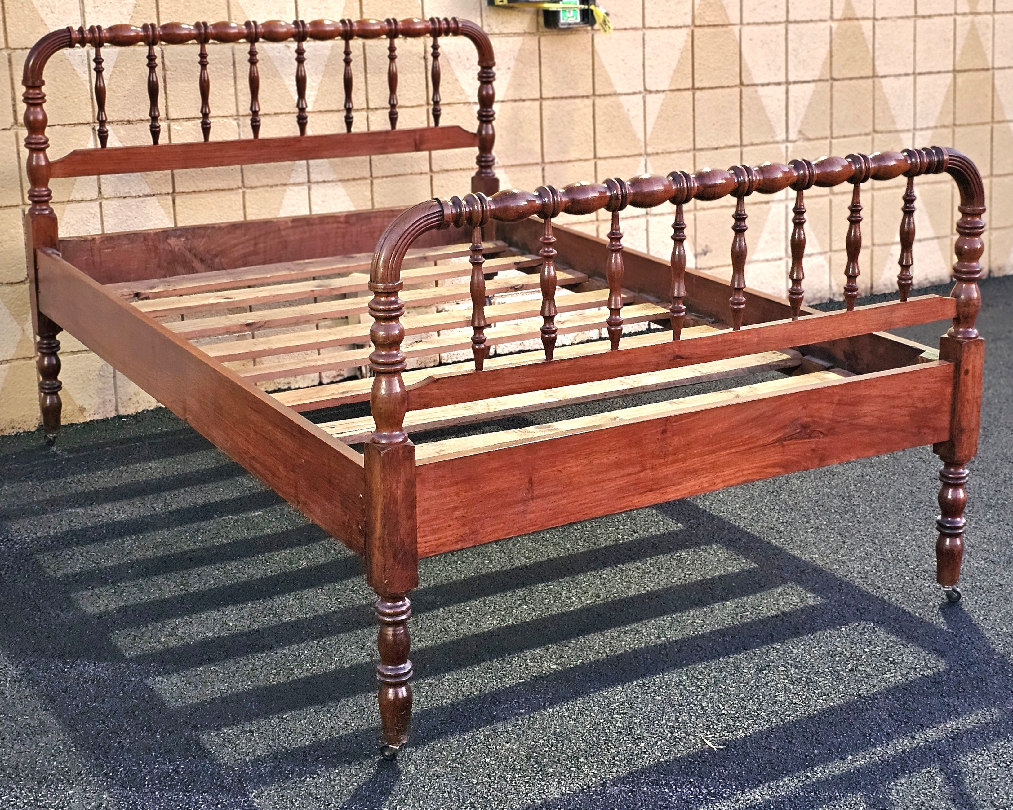  19th Century Refinished Mahogany Spindle Full Size Bed on wheels. 
Measures 53