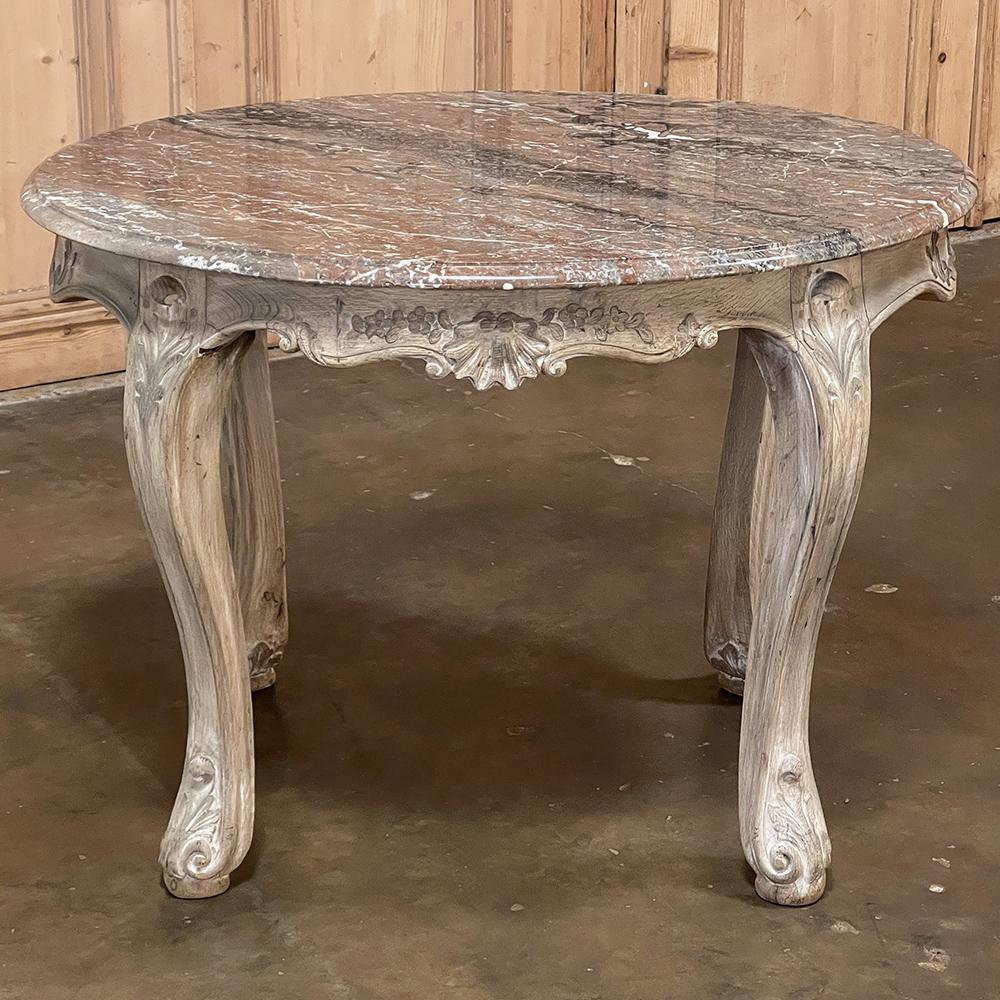 19th century Regence oval marble-top end table from Mons was sculpted from dense, old-growth indigenous oak which was the custom in Mons, France during the period. The framework was first handmade with the strong, durable wood, then joined with