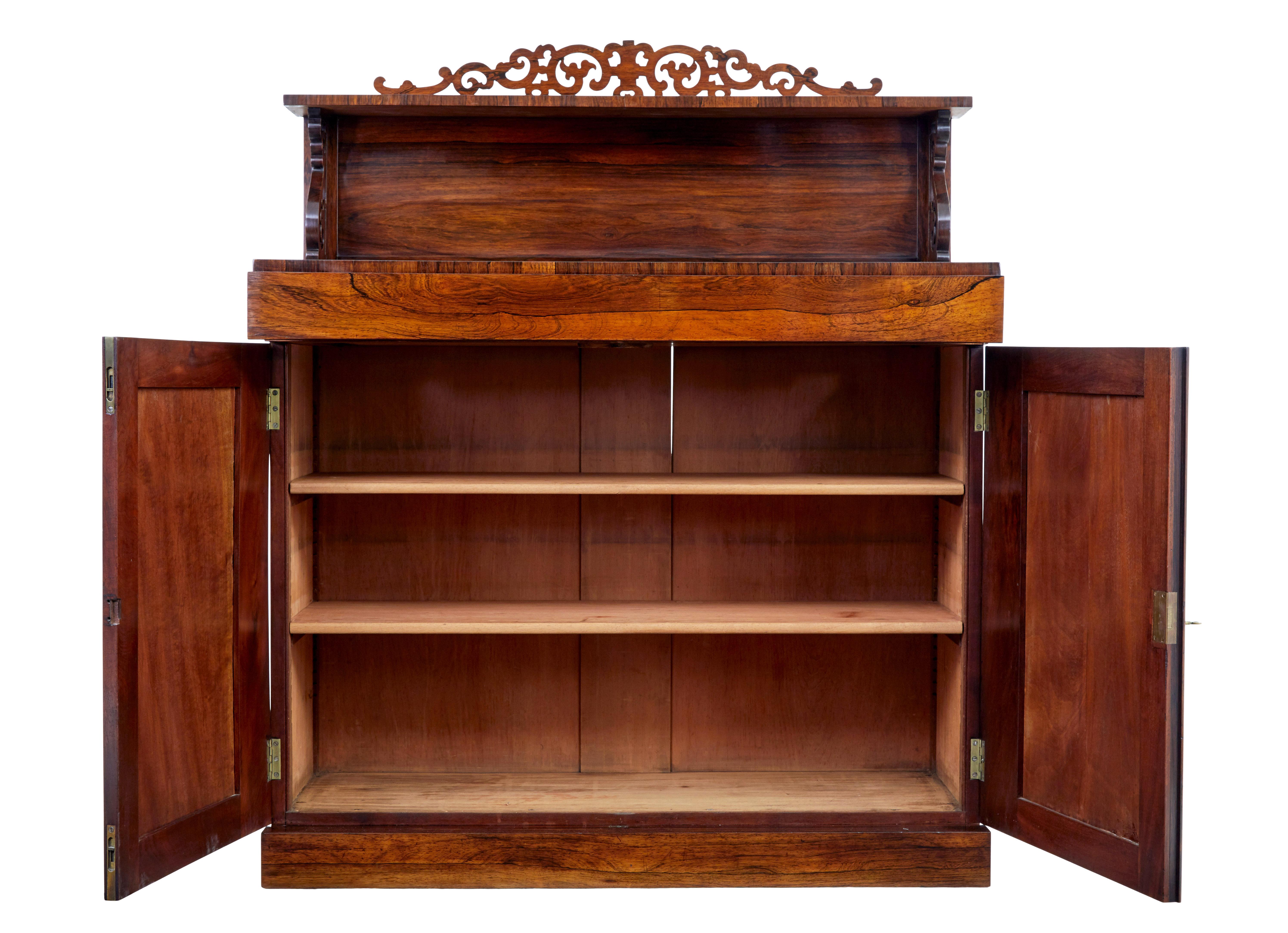 Regency 19th century palisander chiffonier sideboard, circa 1820.

Good quality sideboard of small proportions. Comprising of 2 sections held together by wooden braces.

Top section with fret work detailing gallery, scrolled supports leading to the