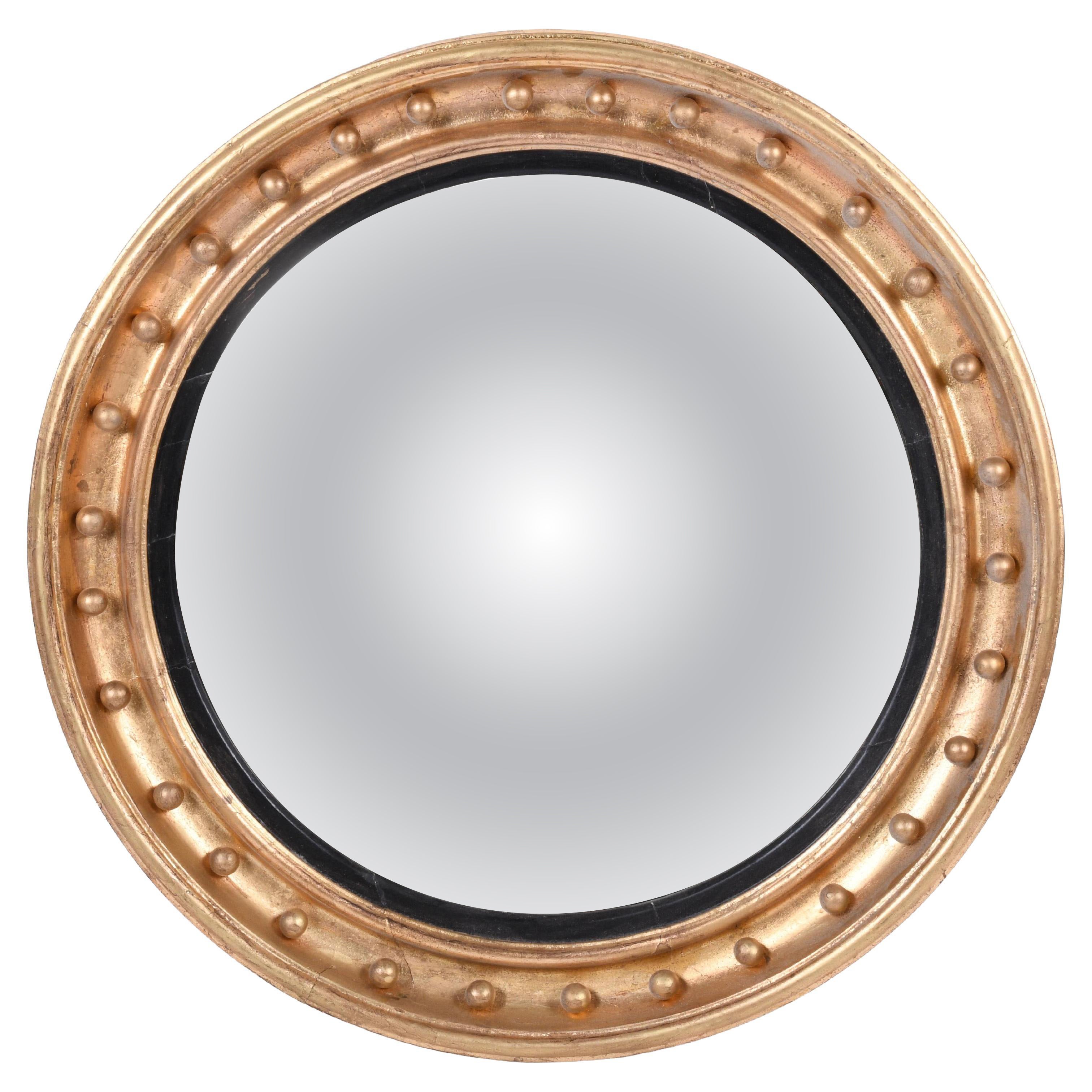 19th Century Regency Convex Parcel-Ebonized Giltwood Mirror