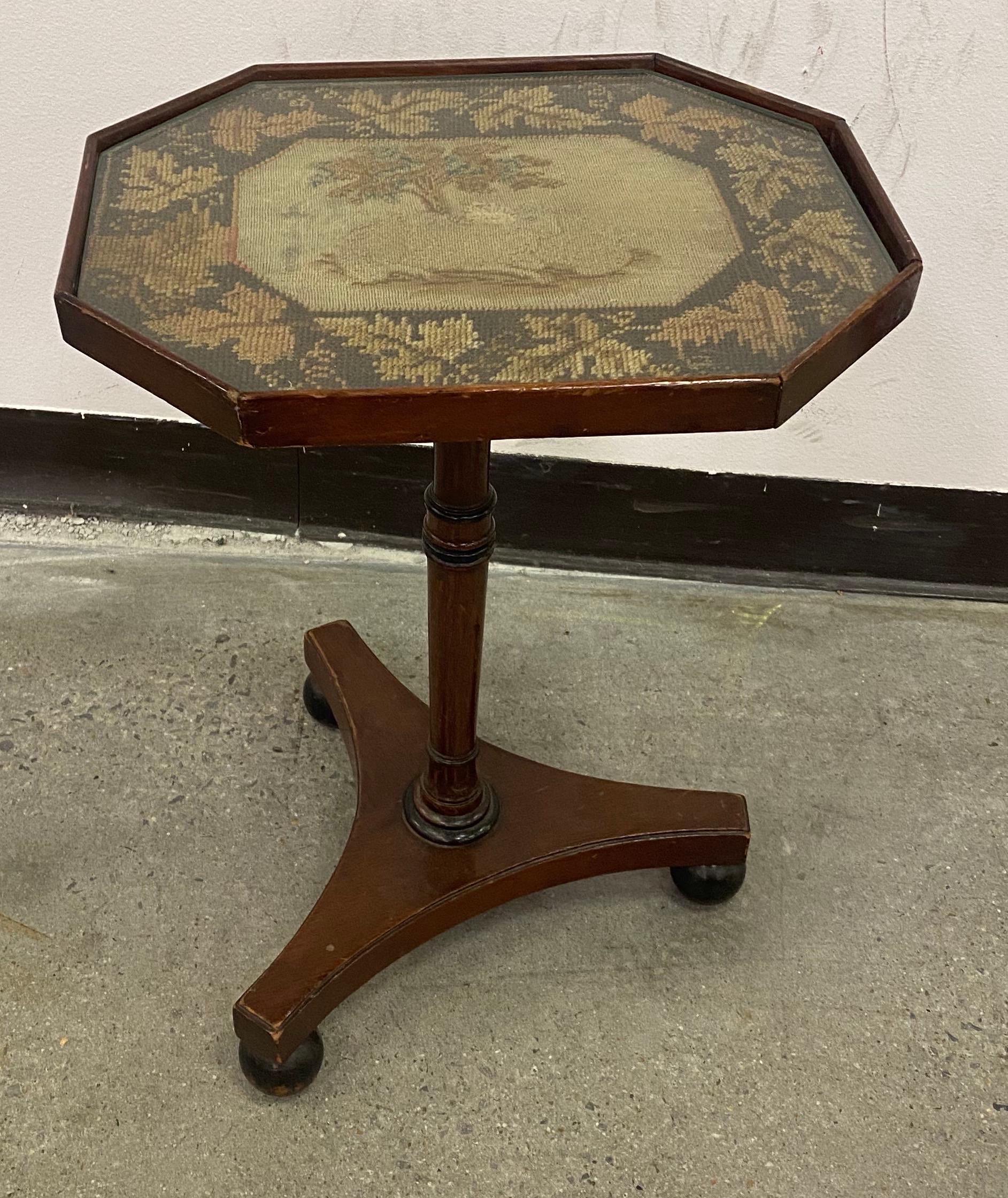 Great little 19th century English Regency embroidered top mahogany side table on ball feet. Top is made of a embroidered scene of sheep resting under a tree. Topped off with cut glass to protect.