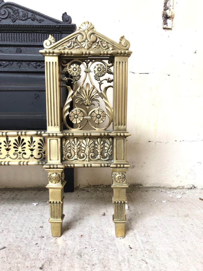 A large and impressive Regency brass and cast iron fire grate.
The solid brass apron is pierced in acanthus leaf design with matching twin reeded 
support columns. The decorative cast iron back has fine detail surrounded by foliage
in Classic