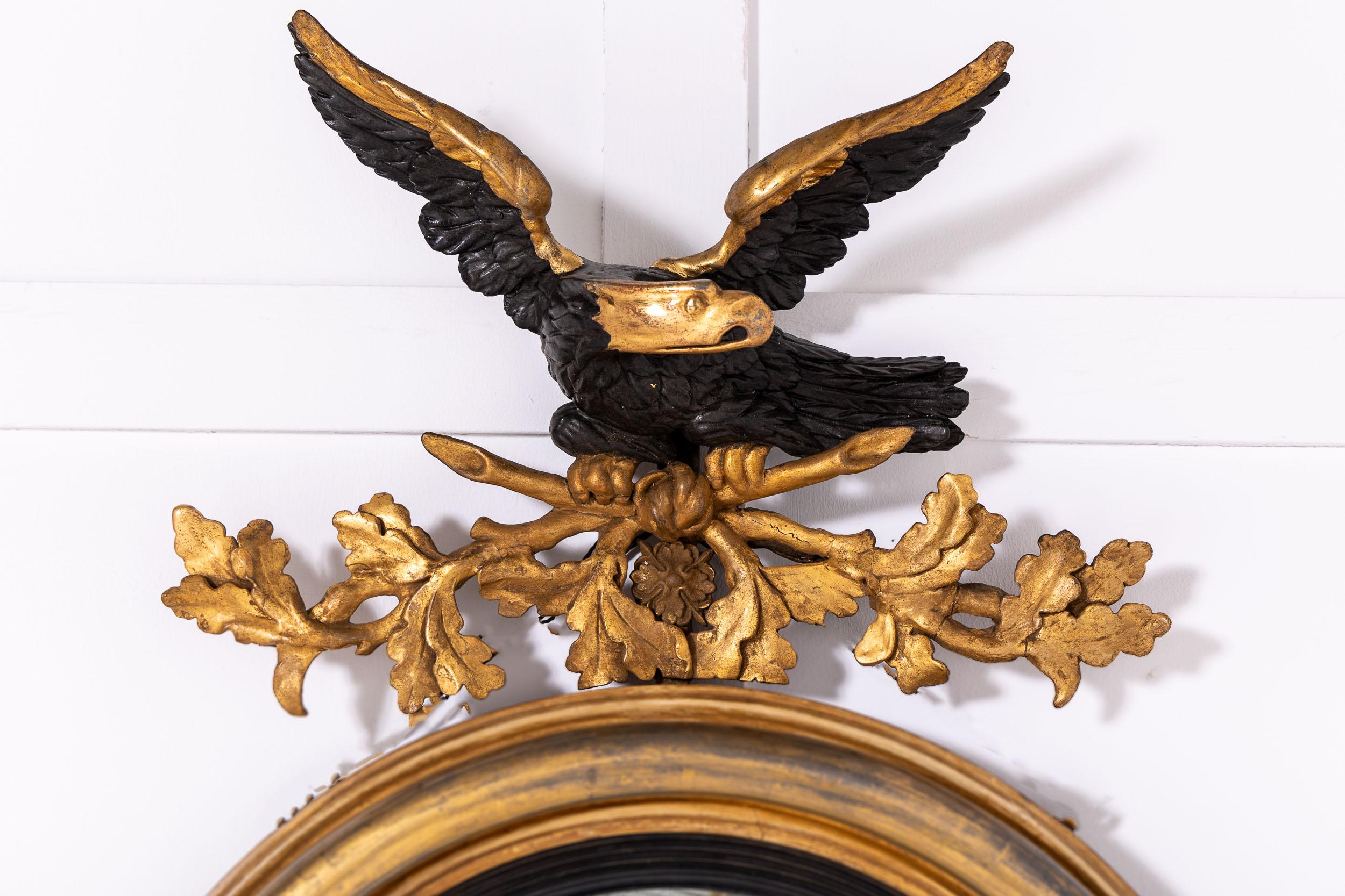 An Excellent and Unusual Regency Period Convex Mirror With Hunting Horn and Wheat Sheaf Motifs.

A fine regency period convex mirror with eagle cresting, unusually rendered in black and gold rather than simply one or the other. The eagle sits atop