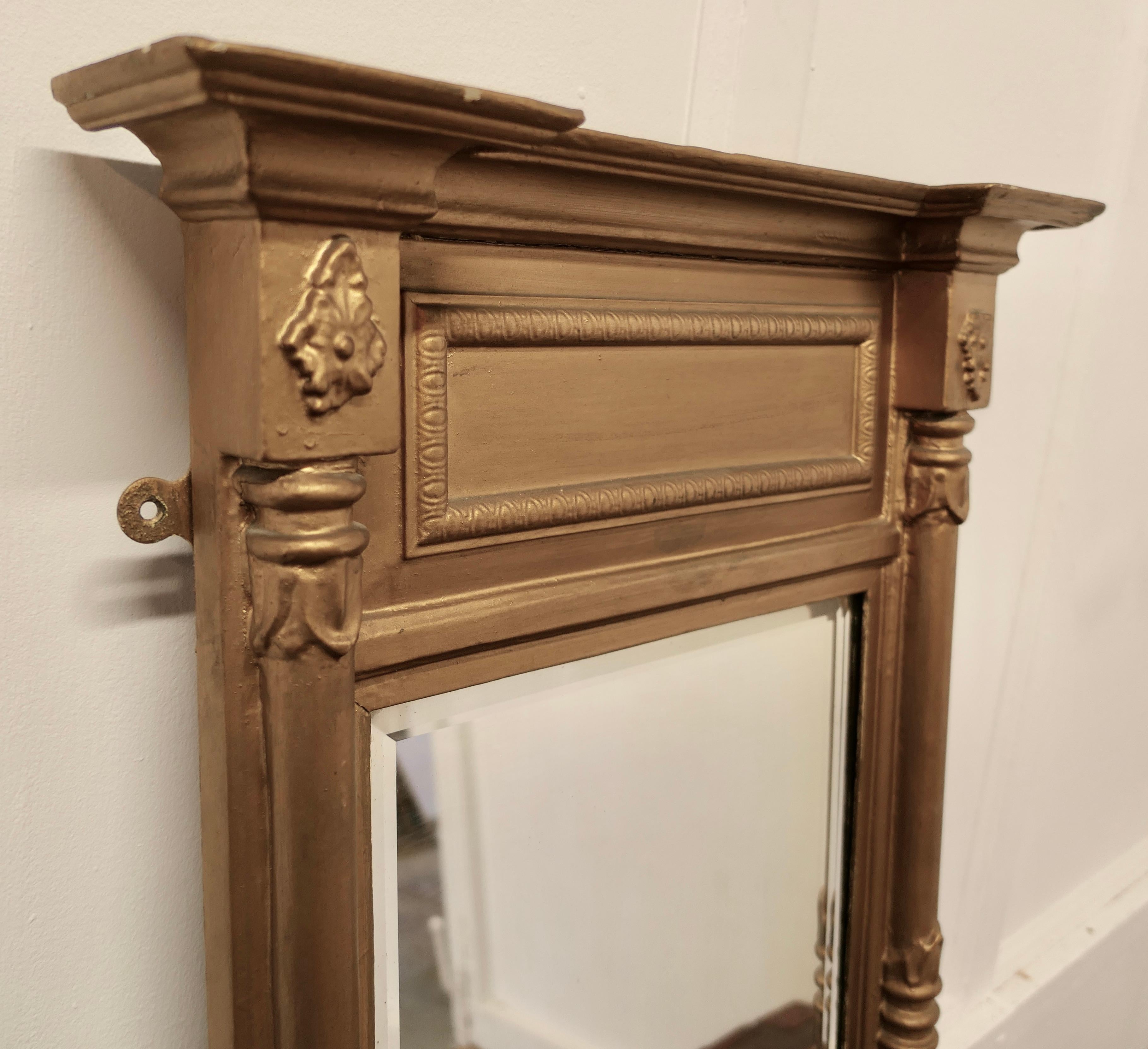 19th Century Regency Gilt Mirror  

The Regency Carved Frame has turned columns at either side and a panel  along the top, the Age Darkened Gold paint on the Frame is in generally good condition
The mirror is bevelled and and in good condition, it