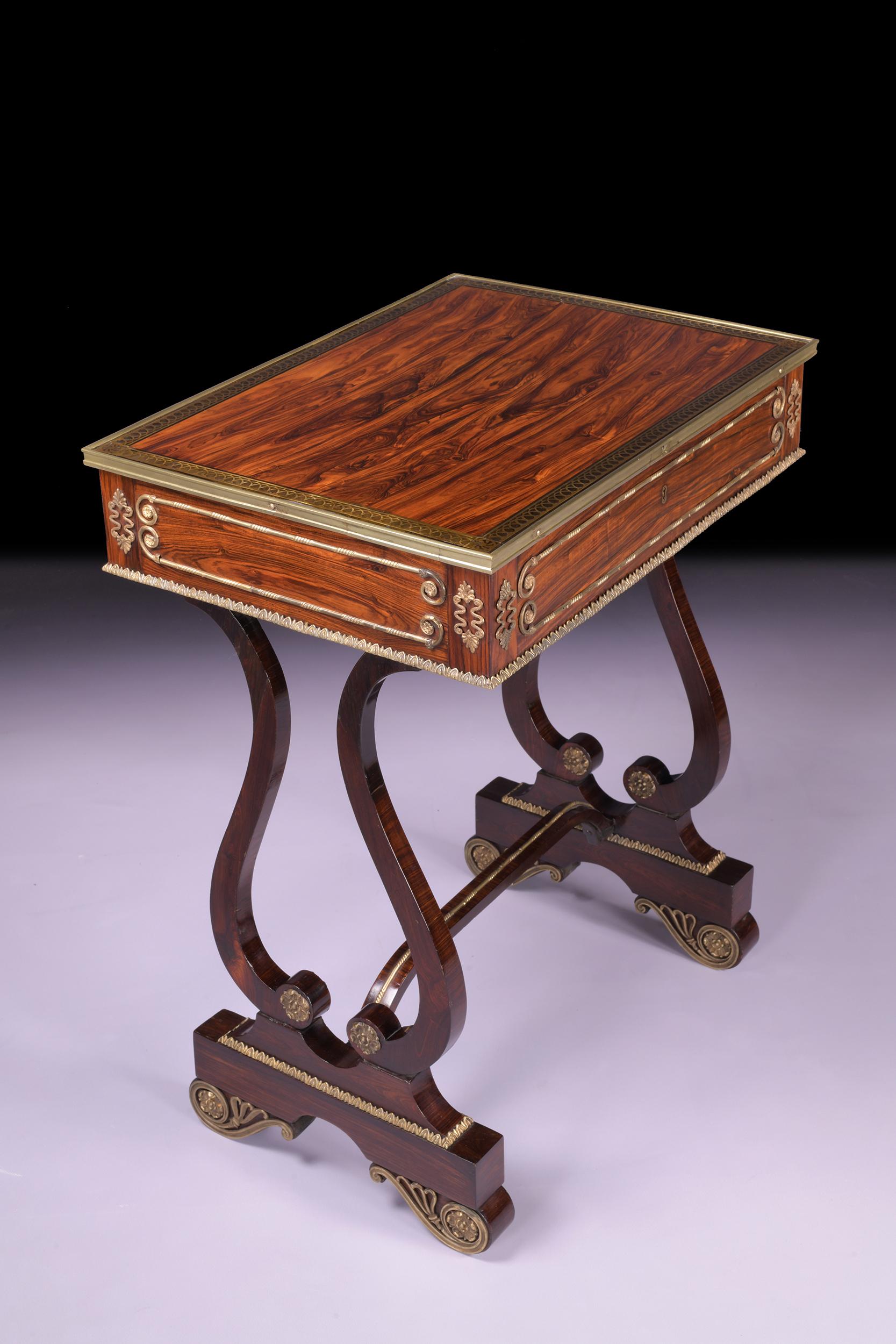 A very fine Regency Gonzalo Alves and crossbanded, ebony and brass inlaid and mounted side table in the manner of John McClean. Applied with gilt bronze mounts, the rectangular top inlaid with an ebony band with stylised leaf brass marquetry, above