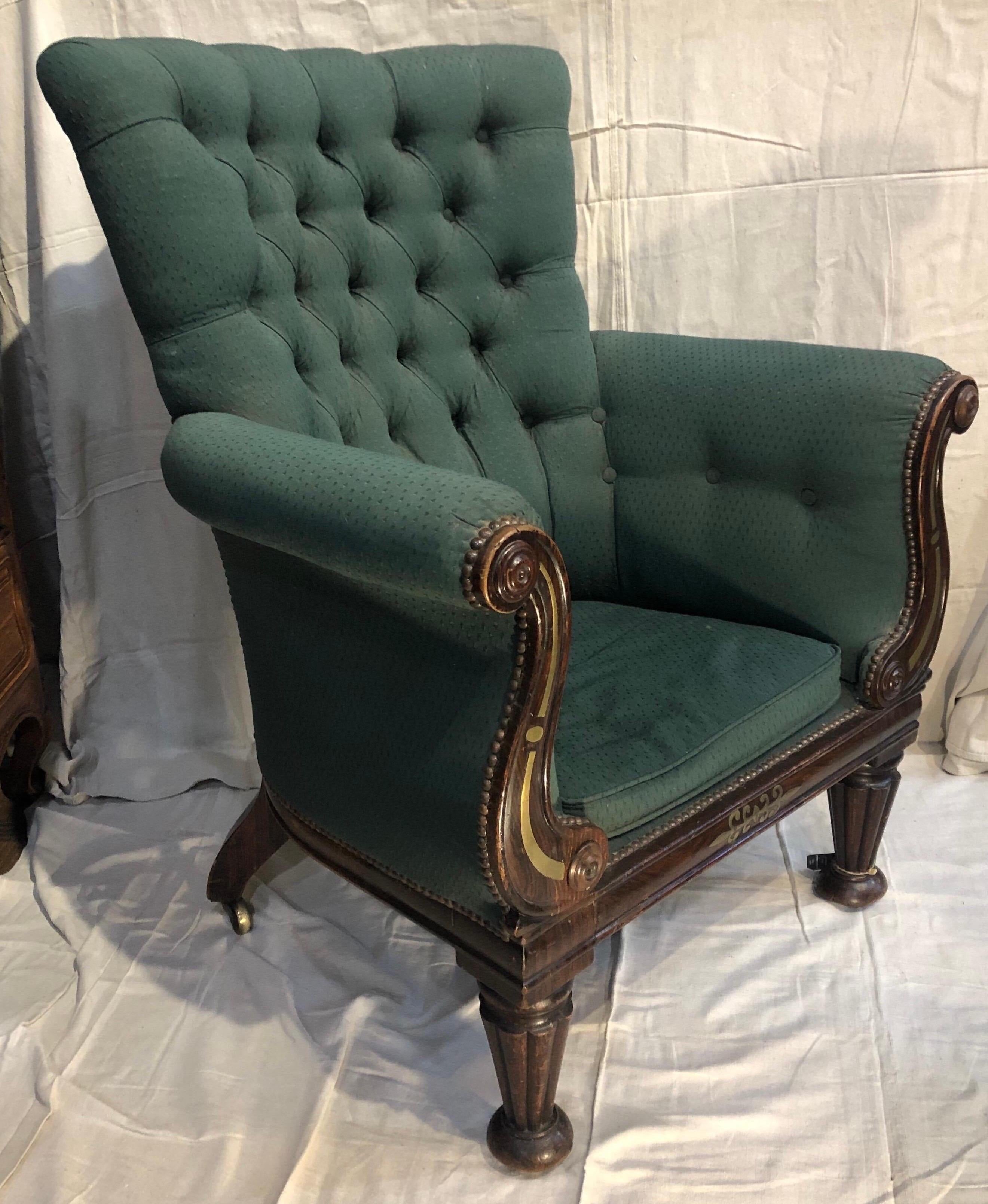 19th century regency library chair with brass inlay and faux rosewood grain. Original castors.