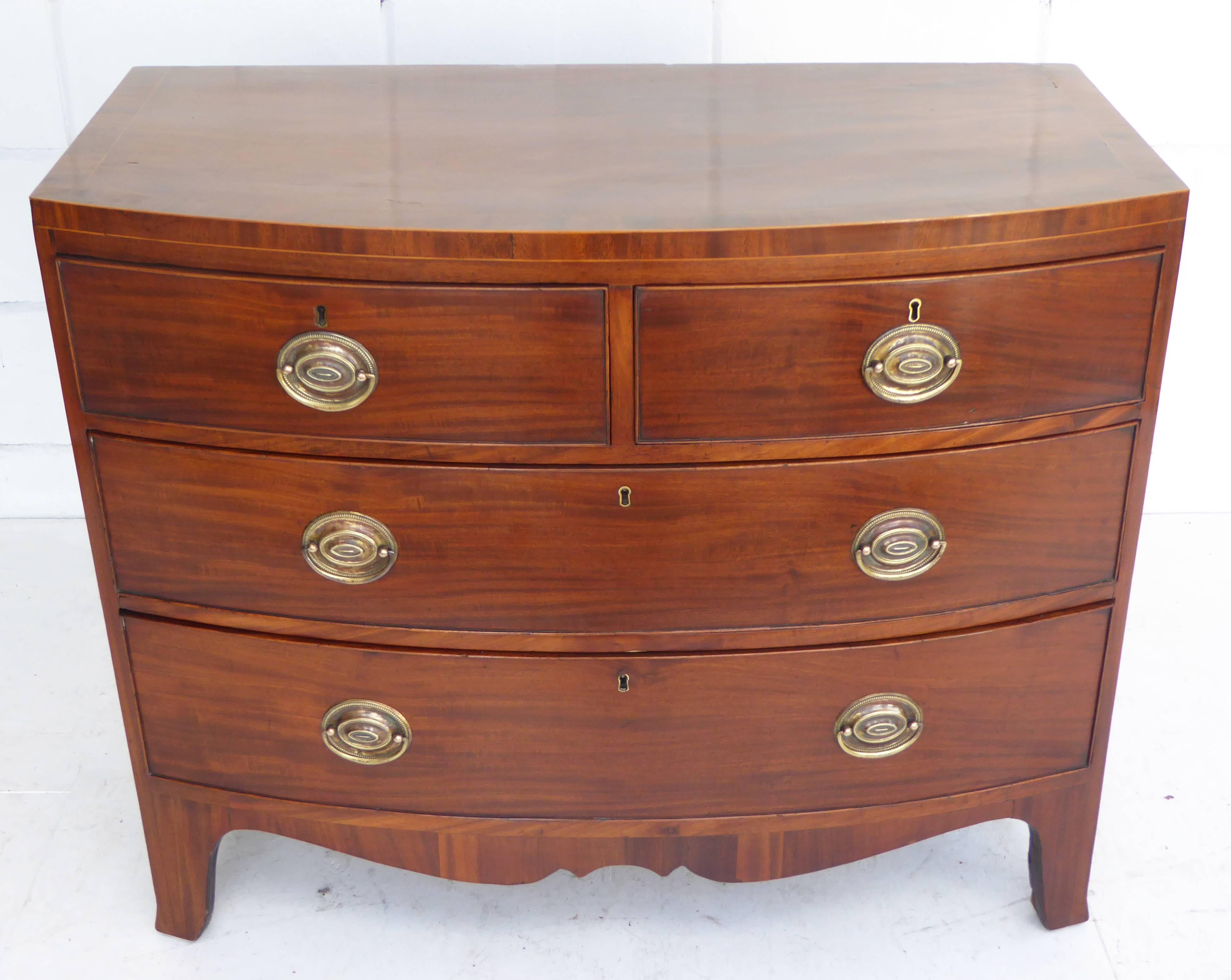 Regency mahogany bow front chest of small proportions with two short drawers to the top and two further long drawers each with matching brass handles below standing on elegantly splayed feet in excellent condition having been completely refinished