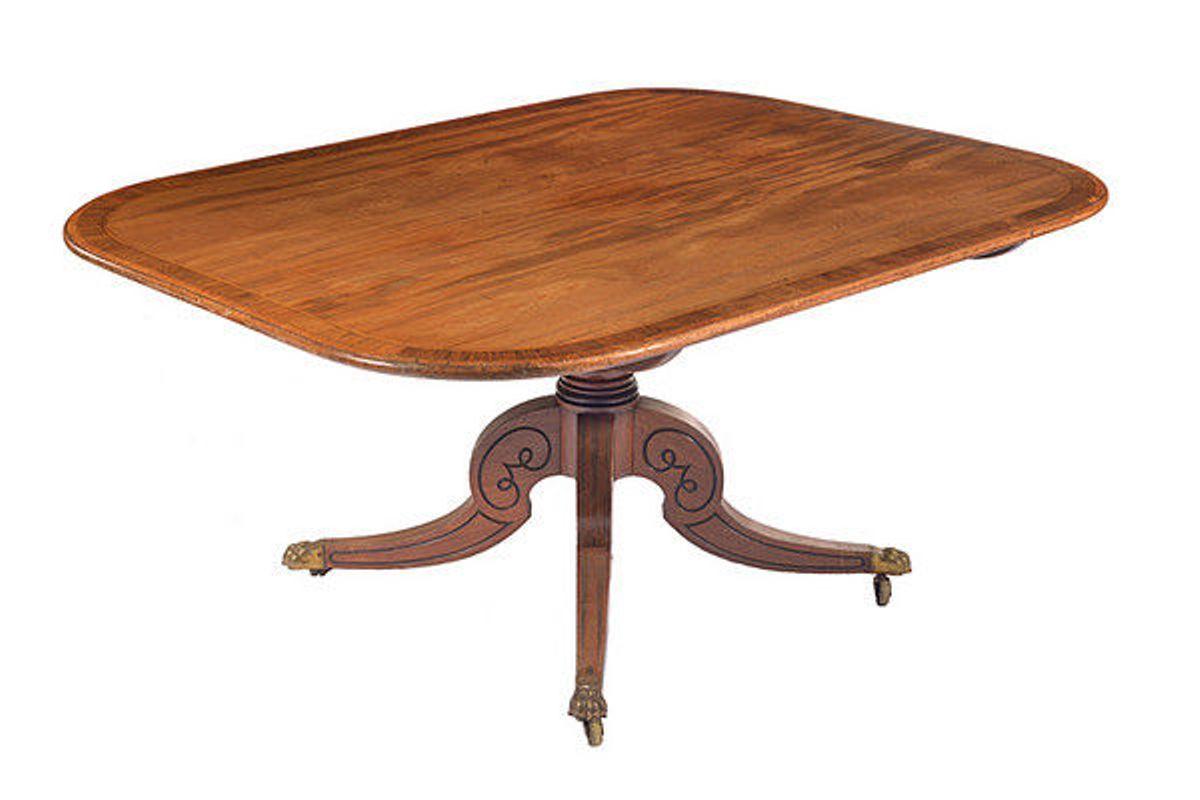 An unusually large 19th century Regency mahogany and rosewood crossbanded tilt top breakfast table.
The well figured top with ebony and satinwood line inlay and rosewood banding, is raised on a ring turned central column that unites with three