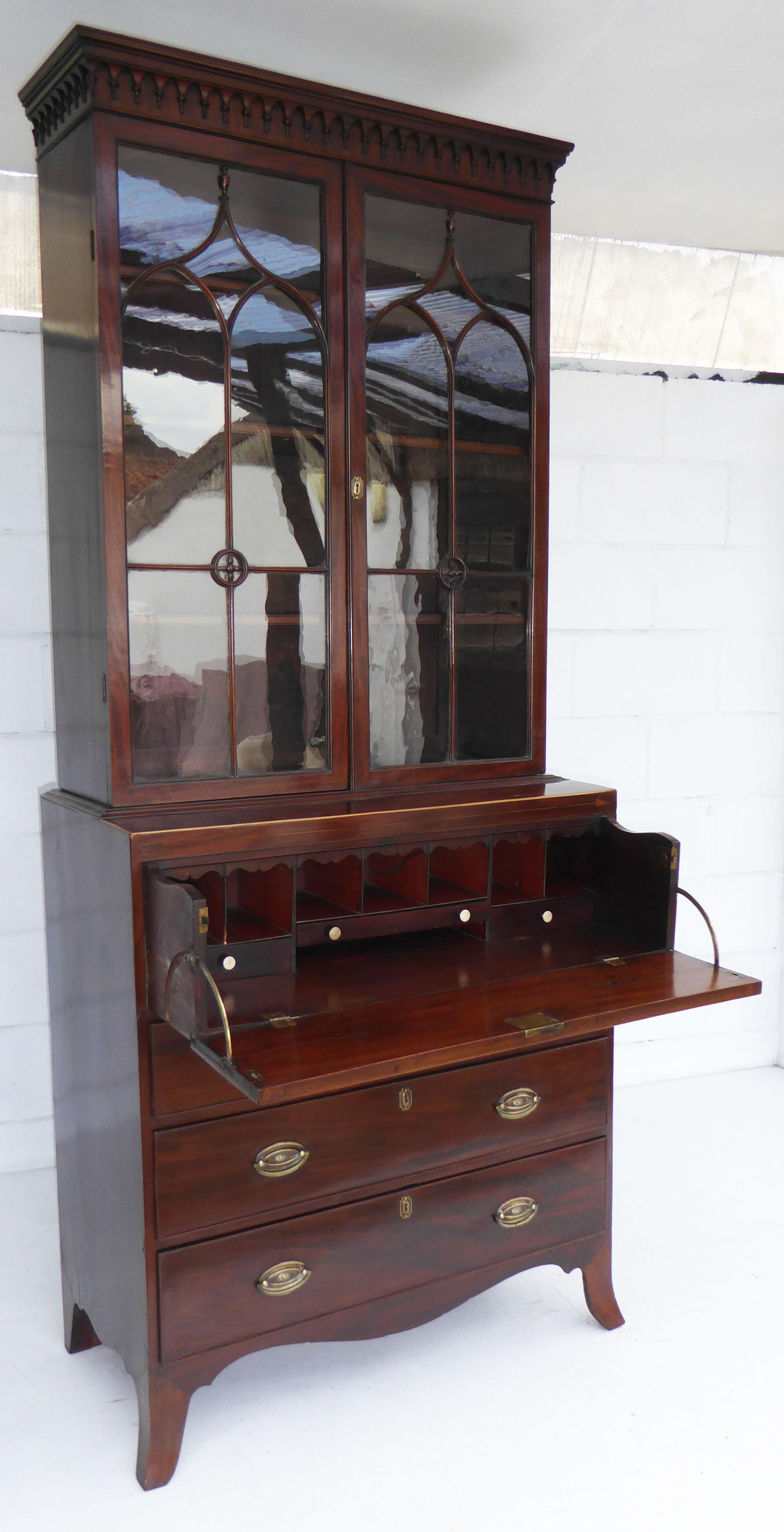 For sale is a good quality Regency mahogany secretaire bookcase of small proportions. The top of the bookcase has glazed doors, opening to reveal adjustable shelves. Below this there is a large drawer with a drop front which opens to show a fully
