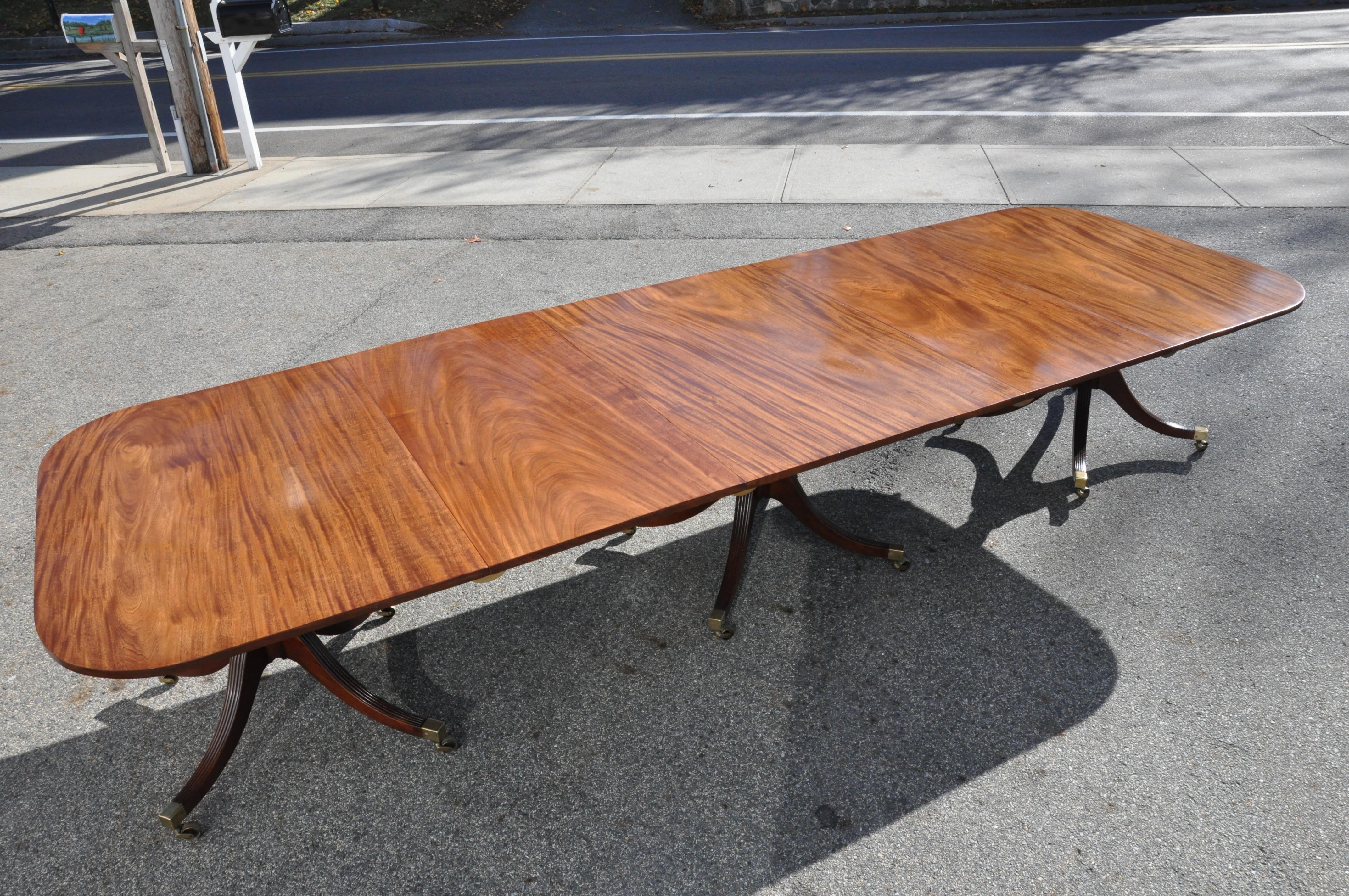 Well figured Cuban mahogany period dining table with original leaves. Three tip top pedestals and two leaves. The very best of solid, bookmatched mahogany. Wonderful condition, patina and finish

Closed: 51” x 102”
With two 24” leaves. 150” long.