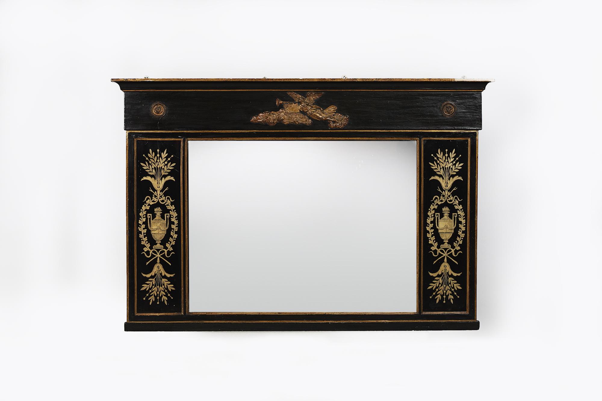 19th century Regency mirror flanked by églomisé panels. The frieze adorned by a gilt angel with trumpet. The églomisé panels decorated with urns, swags and floral motifs.