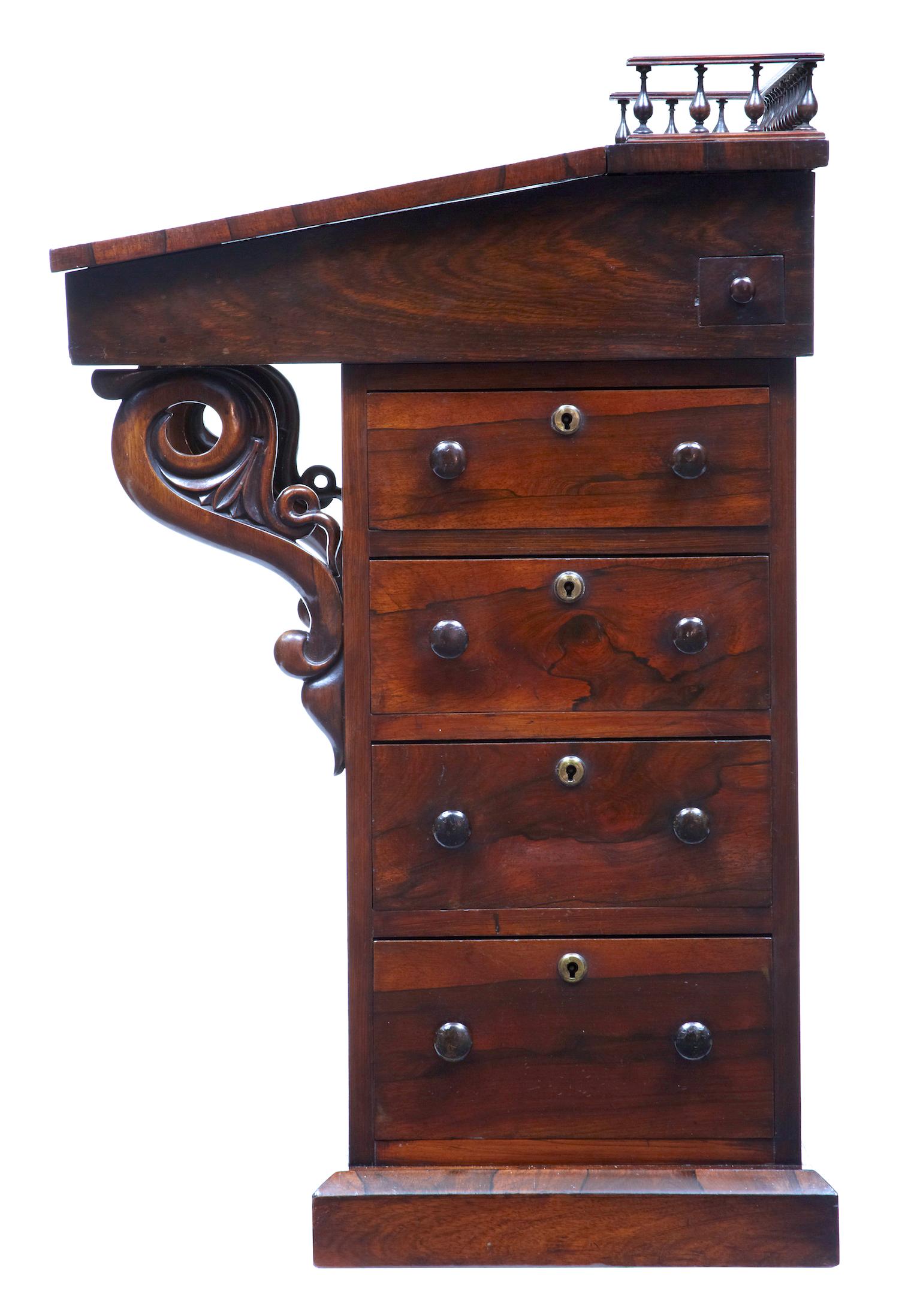 Fine quality regency davenport, circa 1820. 

Spindle gallery to the top leading to the original leather writing surface. Top opens to reveal a richly colored interior with 2 drawers.
4 lockable drawers to one side with pull out pen tray,