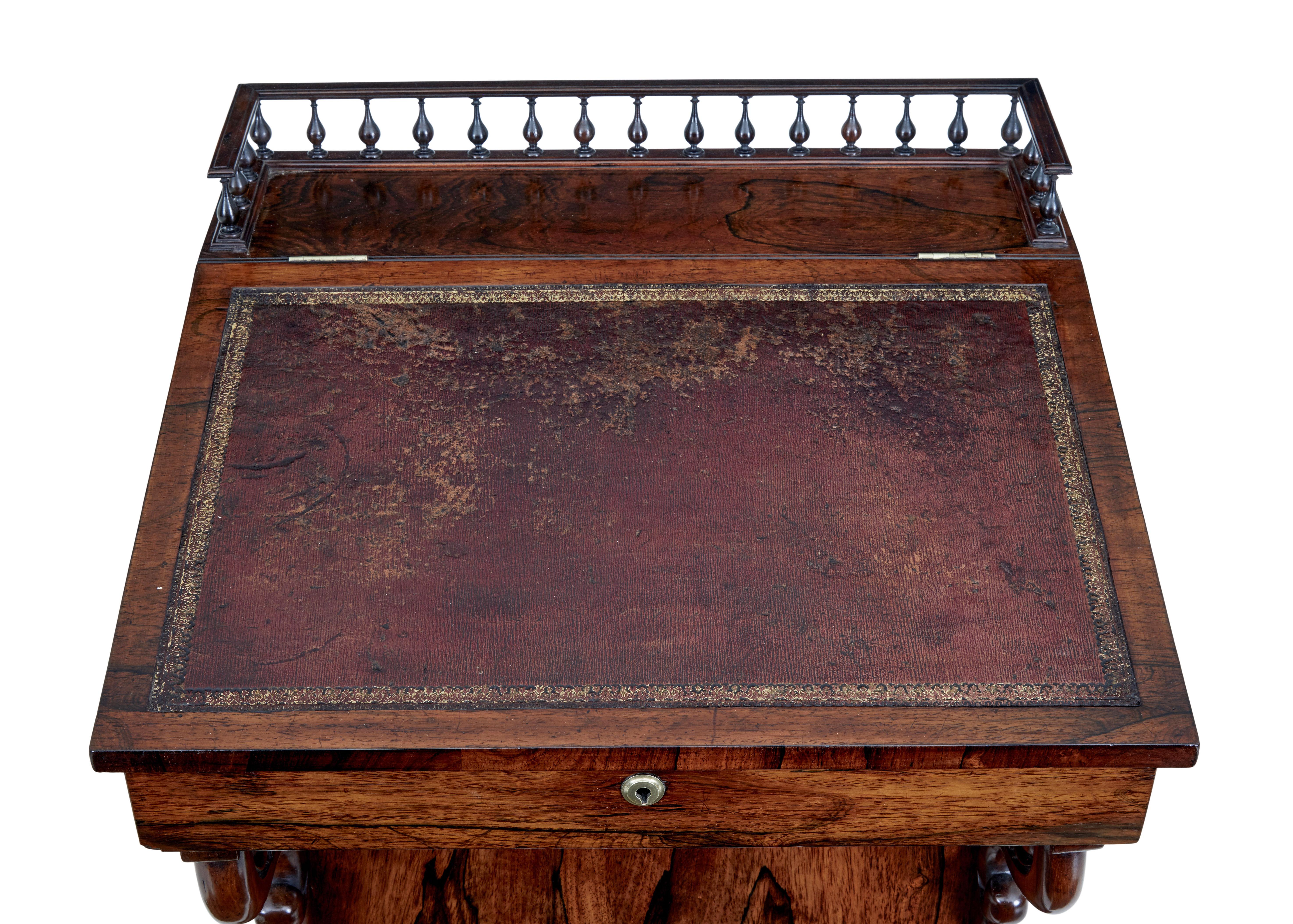 Fine quality regency davenport, circa 1820.

Spindle gallery to the top leading to the original leather writing surface. Top opens to reveal a richly colored interior with 2 drawers.
Writing slope lifts up and with the aid of 2 brass arms,