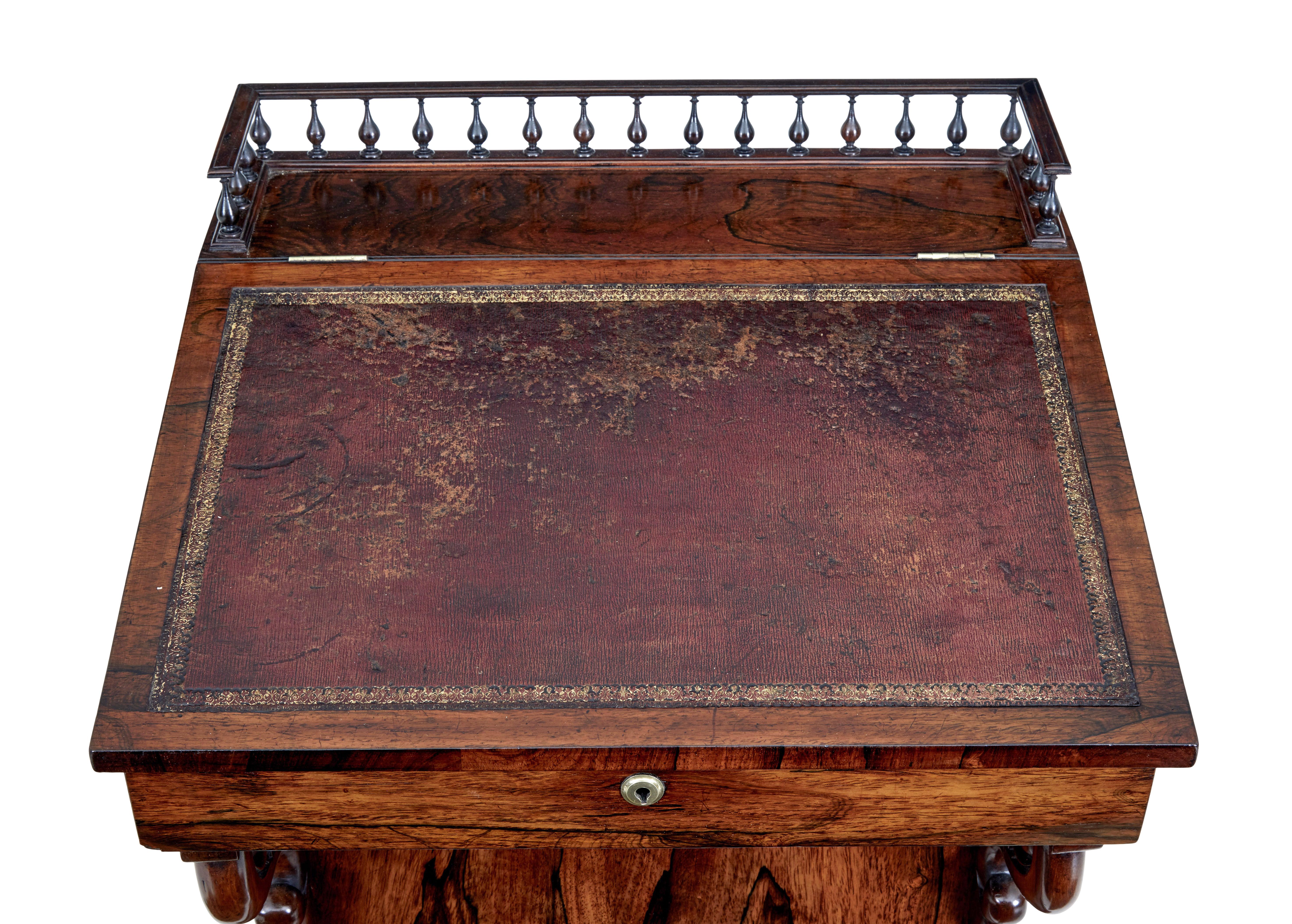 Fine quality regency davenport, circa 1820.

Spindle gallery to the top leading to the original leather writing surface. Top opens to reveal a richly colored interior with 2 drawers.
Writing slope lifts up and with the aid of 2 brass arms,