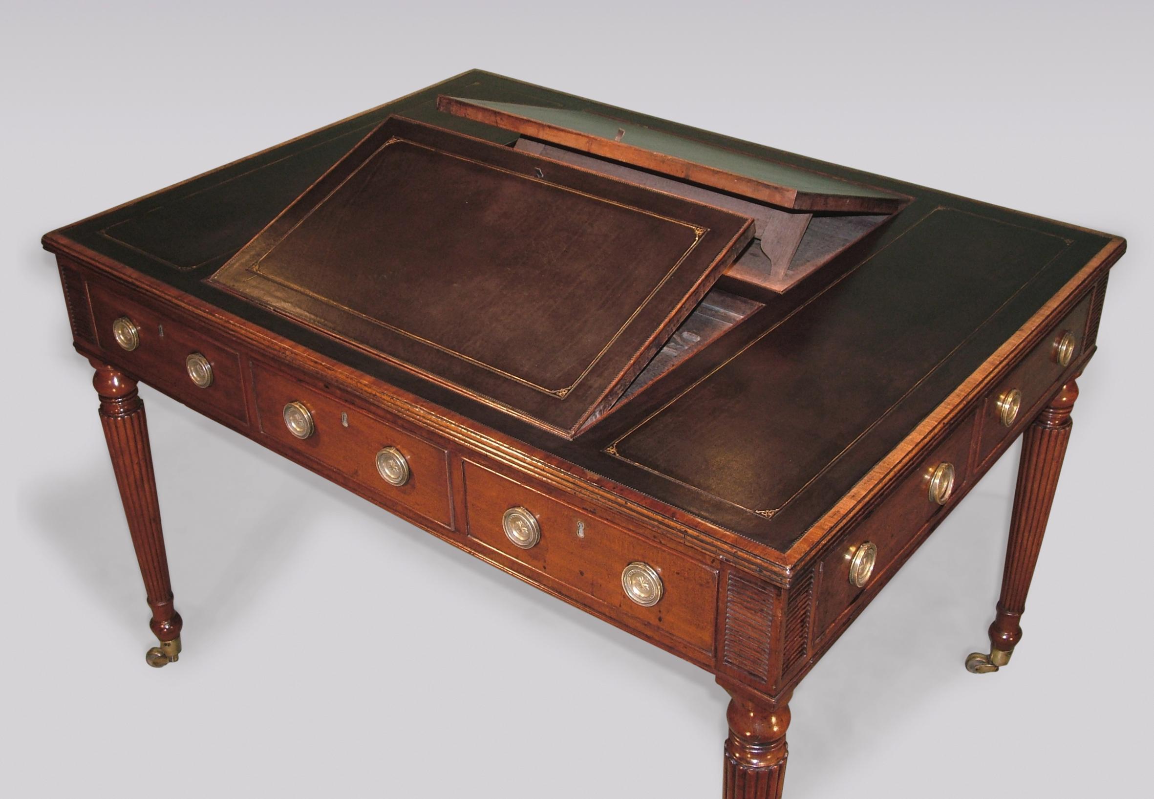 A fine early 19th century Regency period six-drawer mahogany writing table having reeded edged gilt-tooled leather top with two inset reading stands above cockbeaded drawers flanked by “match-strike” reeded panels, supported on baluster turned
