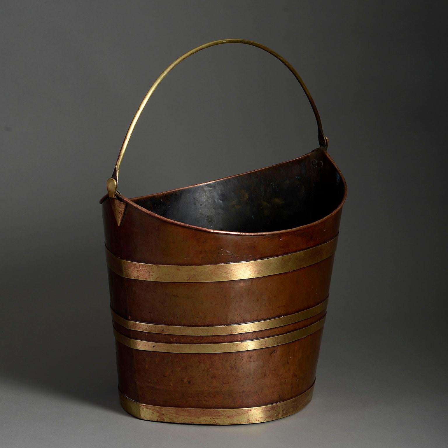An early nineteenth century Regency Period brass bound copper peat bucket, of schooner form, with arched carrying handle.

Height dimension refers to the point at which the handle connects to the bucket.

Circa 1820 England

Dimensions: 15.5 W