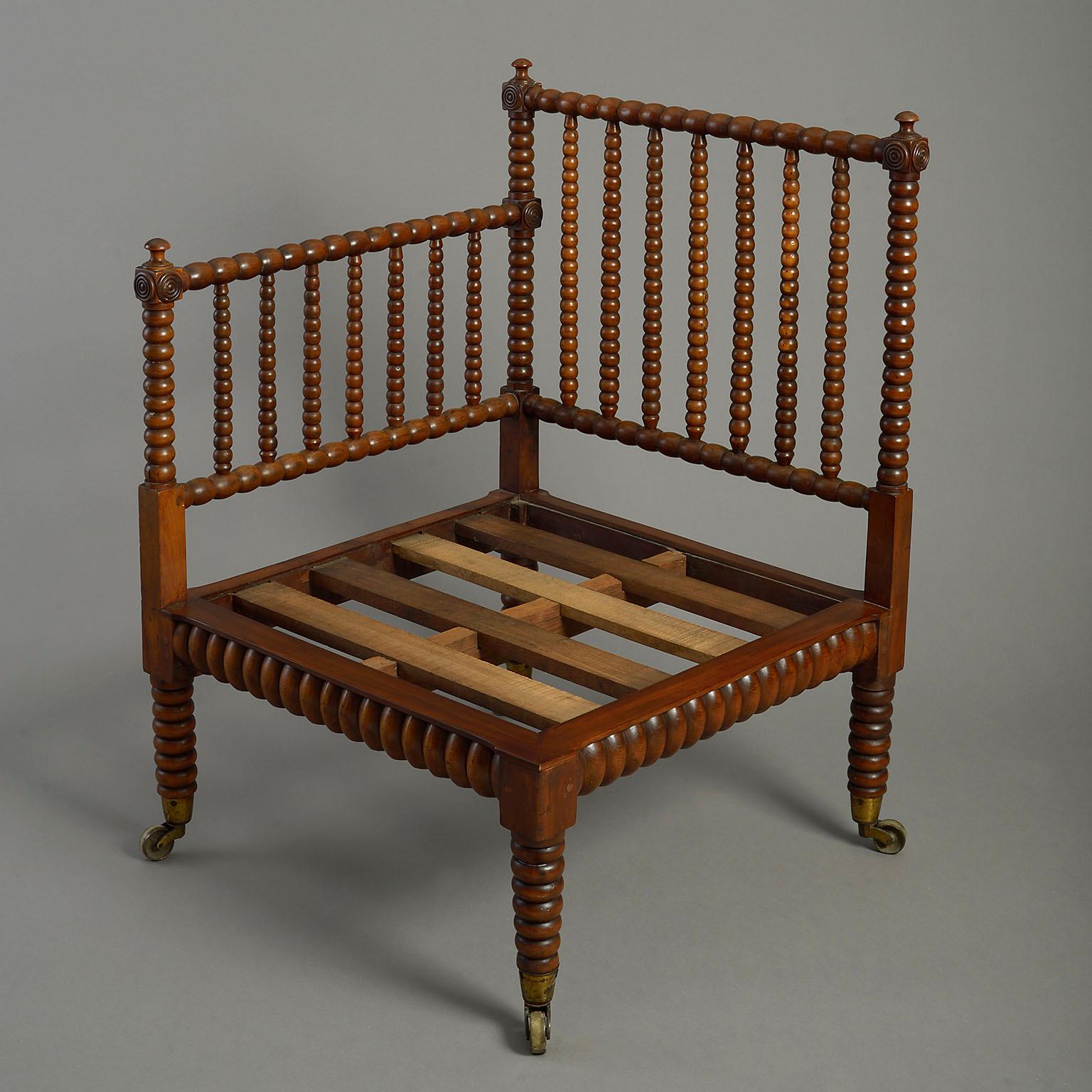 An early 19th century Regency Period bobbin turned yew wood corner chair, the frame headed by finials roundels, the slatted seat supporting a loose leather covered cushion, all raised on bobbin turned tapering legs and terminating in brass
