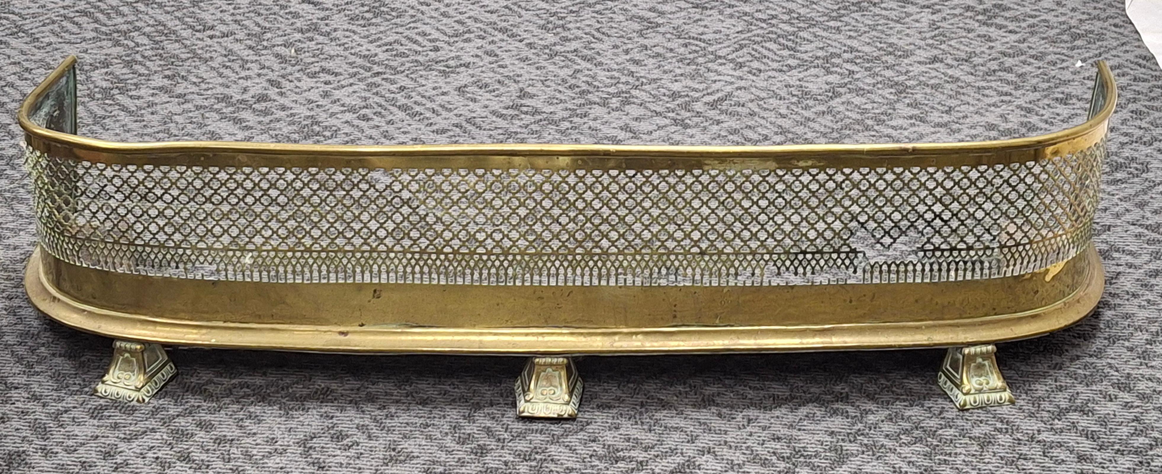 A 19th Century Regency Pierced Brass and Iron  Fireplace Fender
Measures 38.5