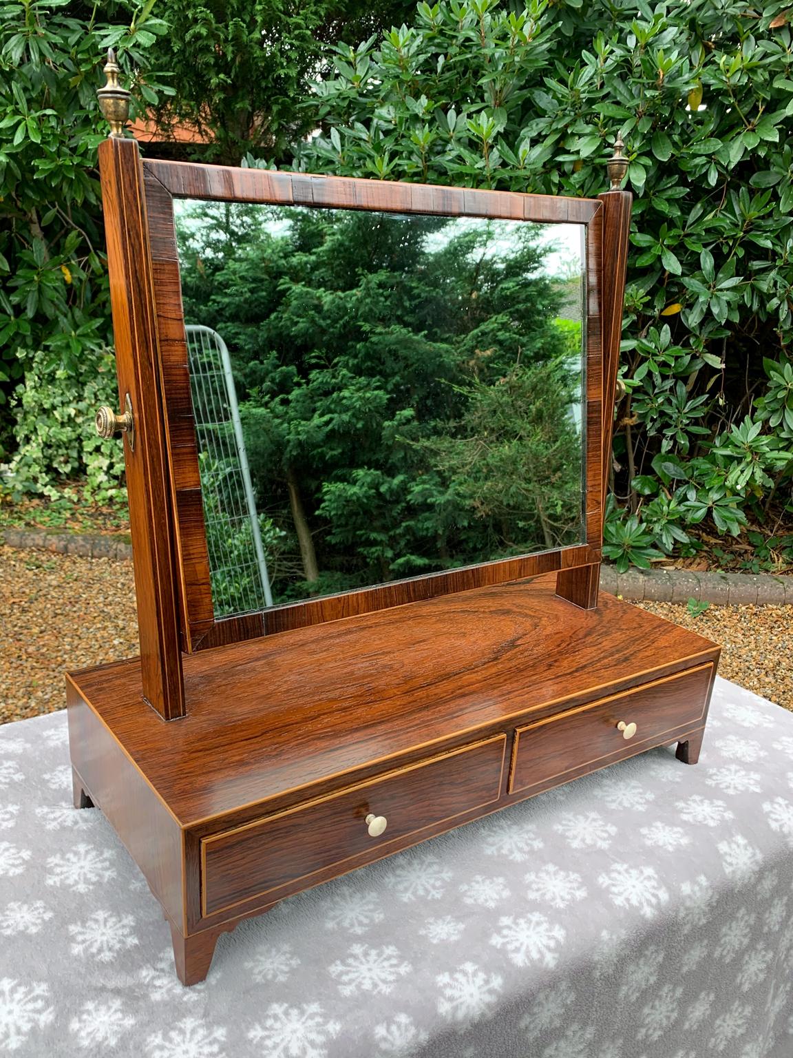 19th century Regency rosewood dressing mirror with two drawers to base,

circa 1837

Dimensions:
Height 23 inches 59 cms
Width 22 inches 56 cms
Depth 9.5 inches 24 cms.

                        