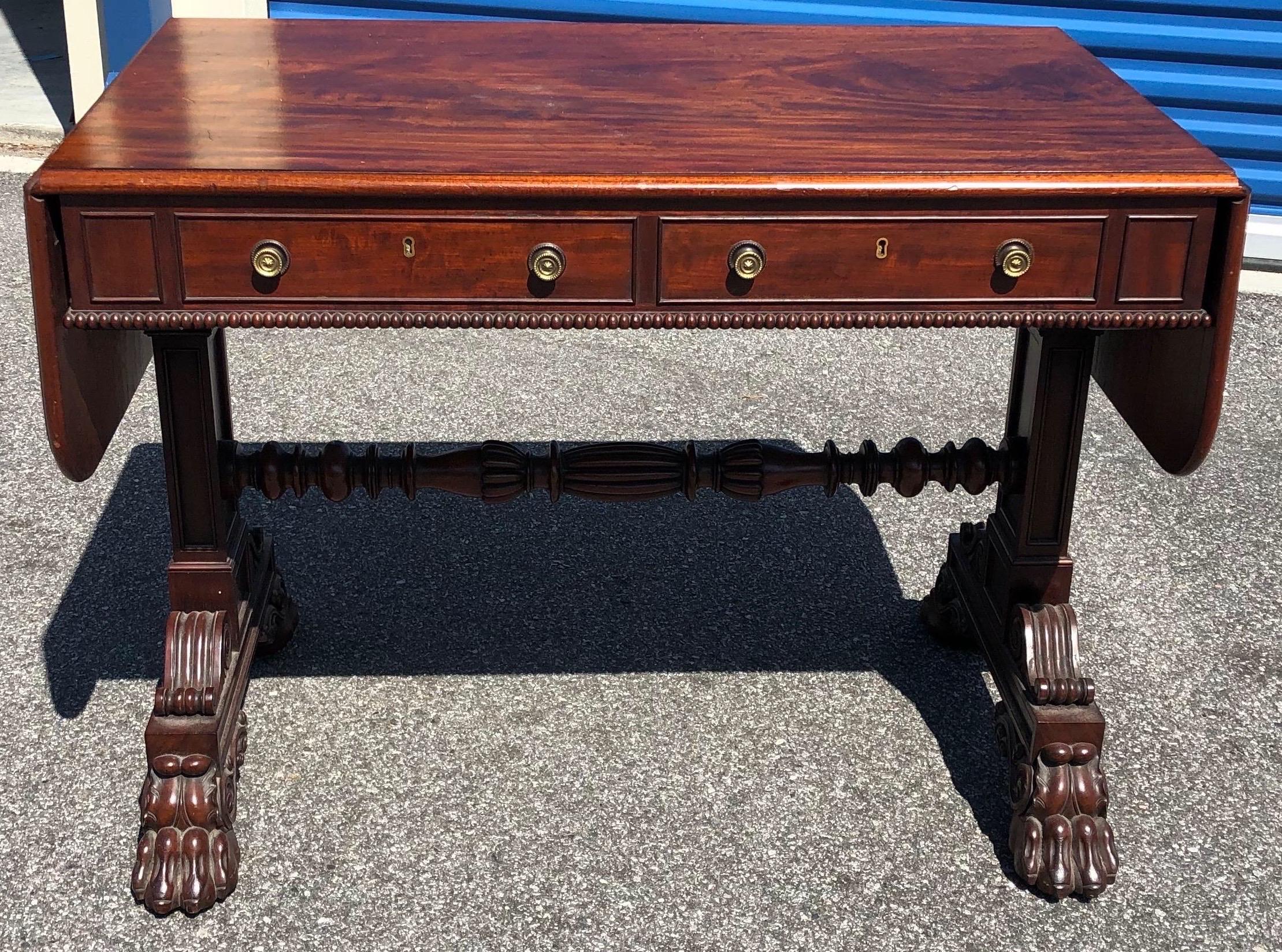 Fine 19th century English Regency mahogany sofa table by Gillows.  Incredible quality carving, color and size on this table stamped 