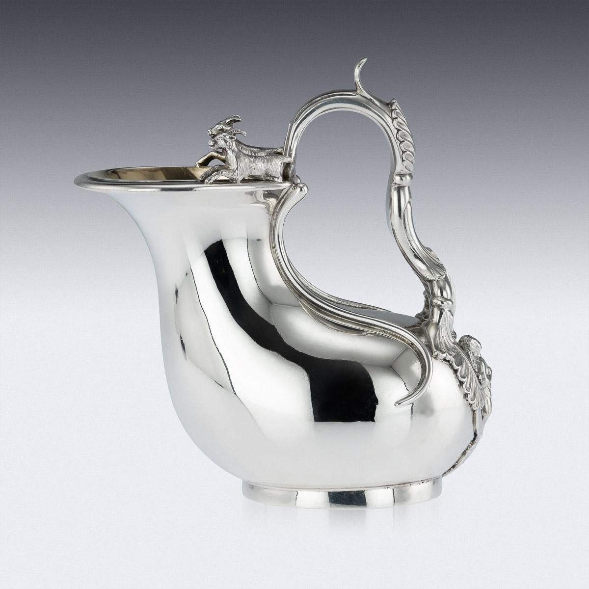 Antique 19th century Regency solid silver Askos jug, applied with an openwork acanthus-capped handle with putto terminal, the rim applied with two fully-modeled rams, inside richly parcel gilt. Hallmarked English silver (925 standard), London, year