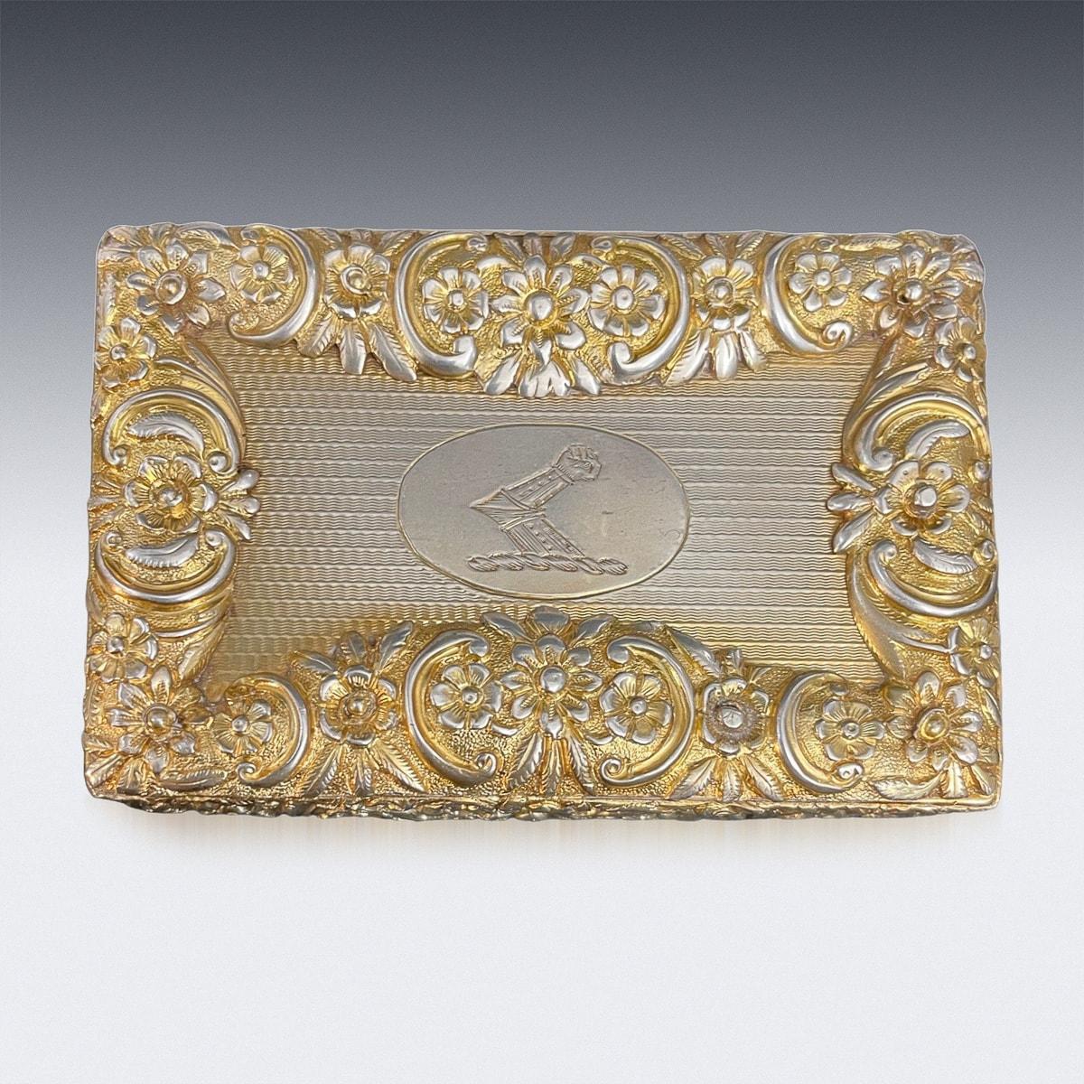 Antique 19th Century Regency solid silver table snuff box, particularly large size, of rectangular form, the cushioned sides are beautifully chased with a floral decoration in relief, the cover applied with cast scrolls and floral border and scroll