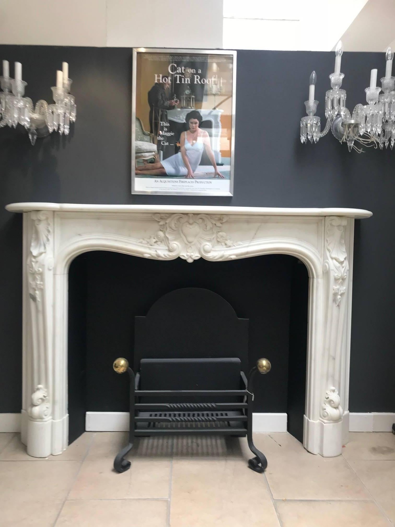 A beautiful early 19th century, circa 1811-1820 statuary white marble chimneypiece surround. This fireplace is English made and hand-carved in Italian marble with French influence of the Louis period. Recently restored after many years in storage.