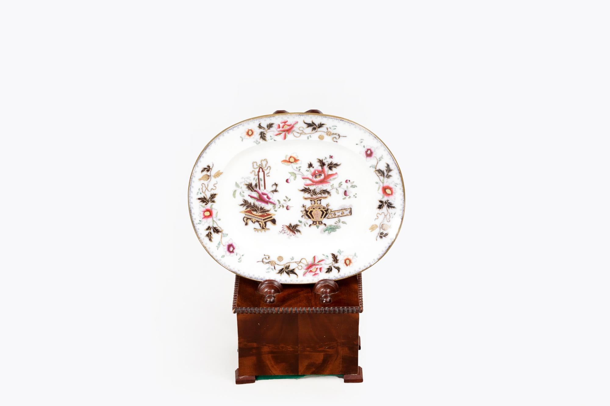 19th Century Regency weighted salver stand having figured mahogany veneers, beaded mouldings, and simple feet. The shaped rectangular moulded back above a rectangular lead-loaded base, with beaded edge and split baluster turned rests. It is