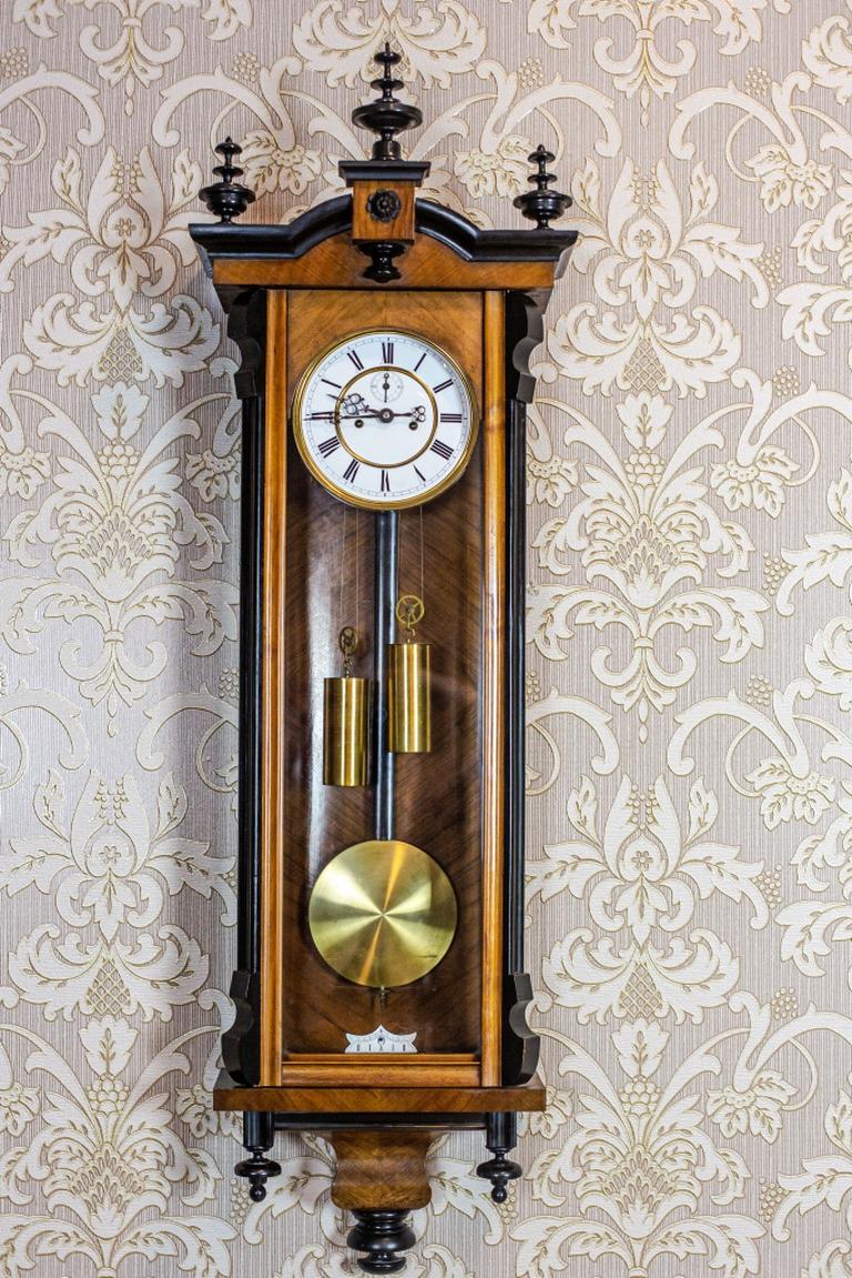 We present you a big clock with a pendulum and a weight-driven mechanism.
The clock strikes full hours and halves.
The case is glazed and topped with a cornice with three finials.

Presented clock is in very good condition.
The mechanism is