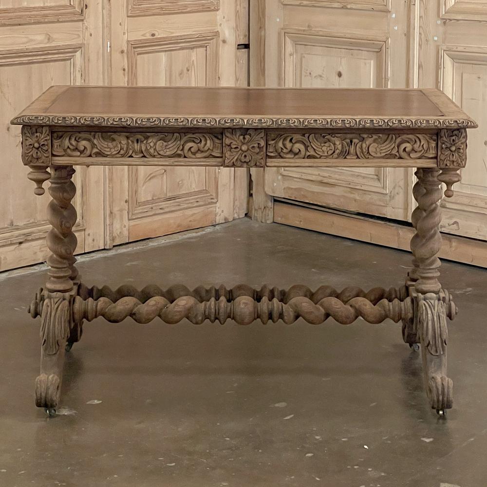 19th Century Renaissance Barley Twist Stripped Oak Desk features clockwise & counter clockwise barley twist columns in pairs on each side, providing support to the elaborately carved apron which conceals two drawers, and connecting to the boldly