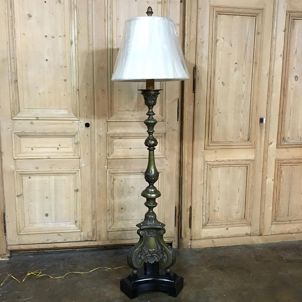 19th century Renaissance cast bronze altar candlestick converted to floor lamp ~ Boldly cast in bronze and placed on hand carved wood base.
Newly electrified and fitted with a hand sewn silk shade, included in the price!,
circa 1870s.
Measures