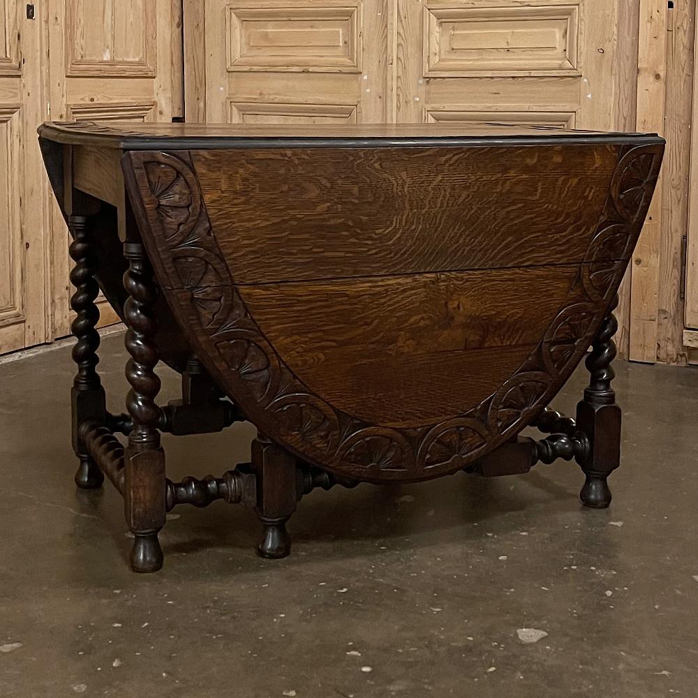 19th century Renaissance gate leg drop leaf barley twist table represents a splendid example of craftsmanship combined with ingenuity! Hand-carved from solid oak to last for generations, it features an oval top when both leaves are extended, each of