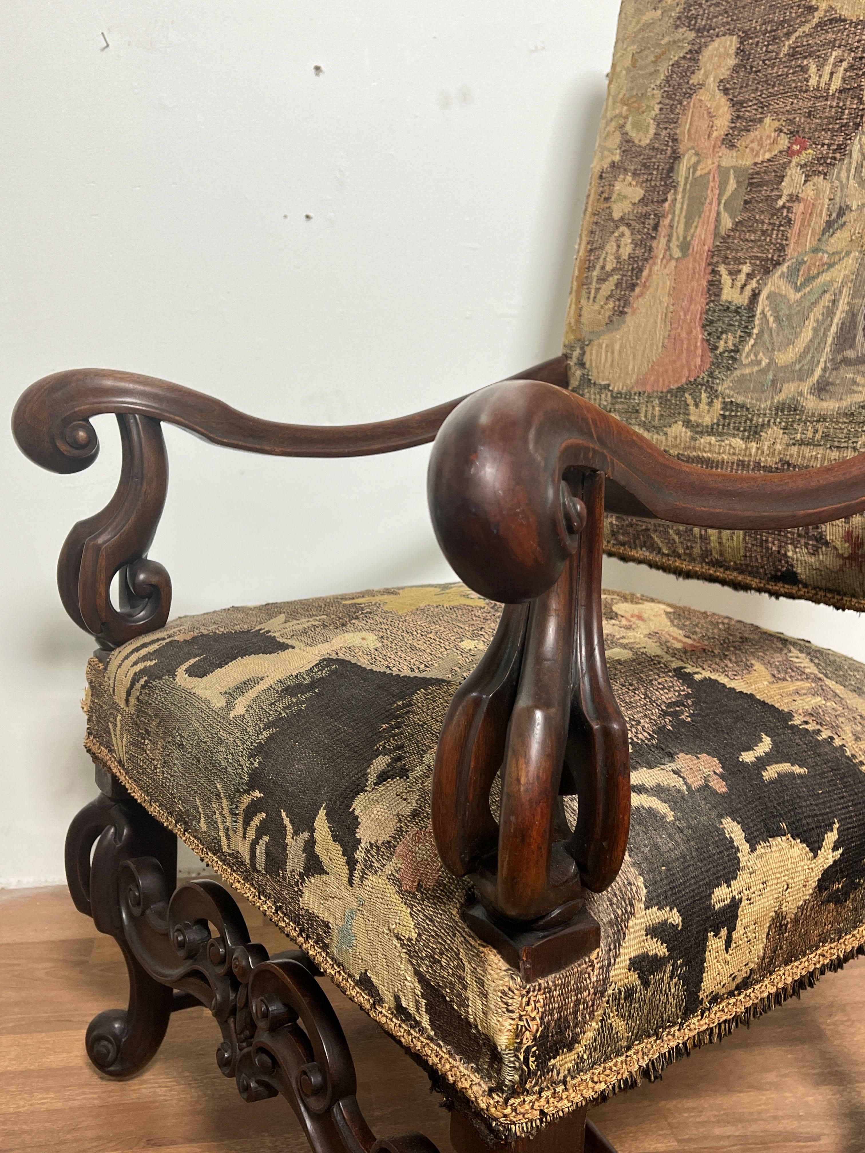 A 19th century Renaissance Revival armchair in masterfully carved walnut, upholstered in an antique Belgian tapestry.