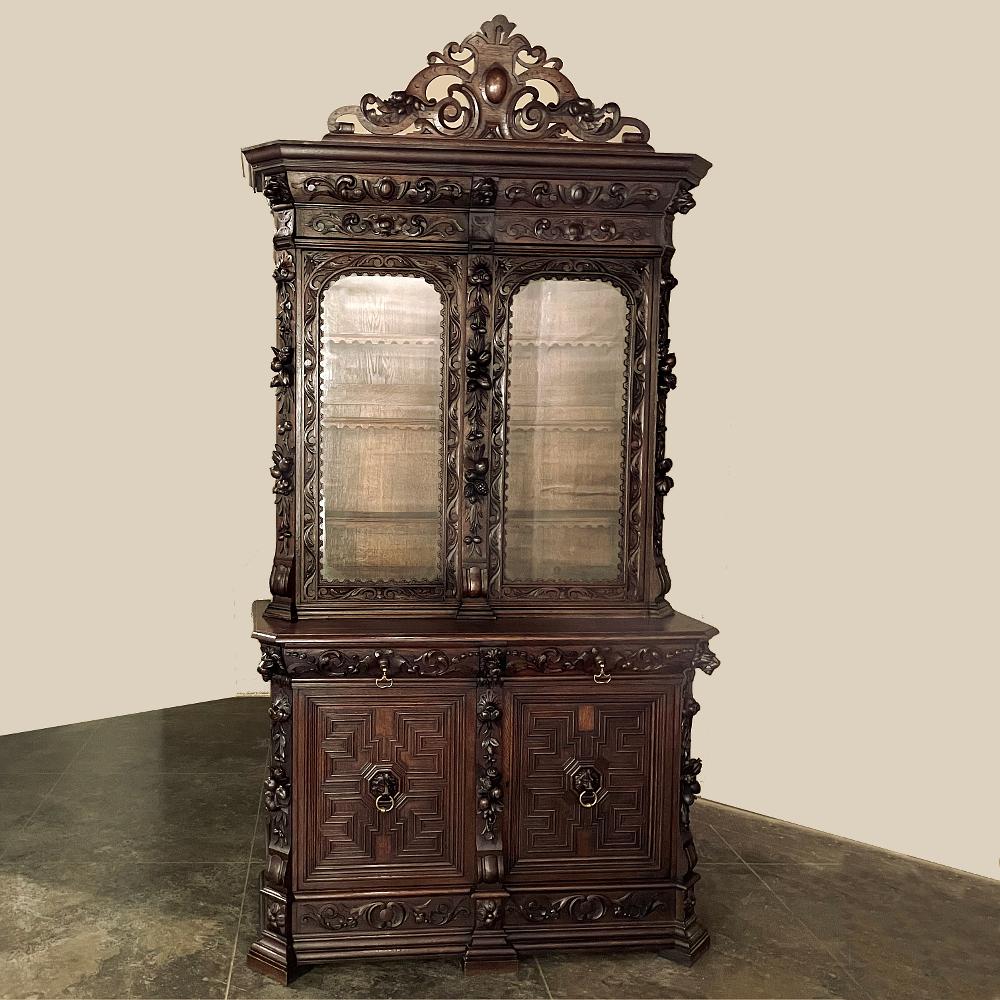 19th century Renaissance Revival bookcase is a magnificent ode to the era, with carved detailing that can only be described as sculpture from the arched crown to the baseboard below! Rendered from old-growth oak to last for centuries, it features a