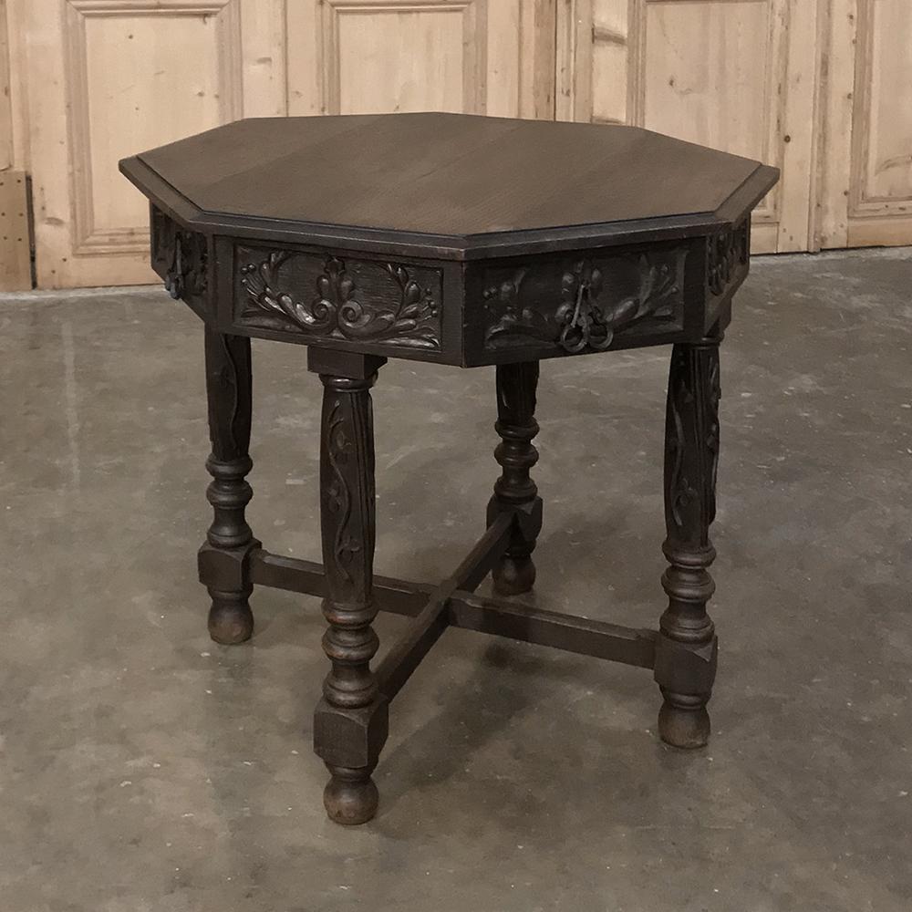 19th century Renaissance octagonal end/game table is a wonderful example of the woodcrafter's art, with carved rim around the octagonal top, a carved apron surrounding the entire piece, and carved legs providing support. Four drawers add wonderful