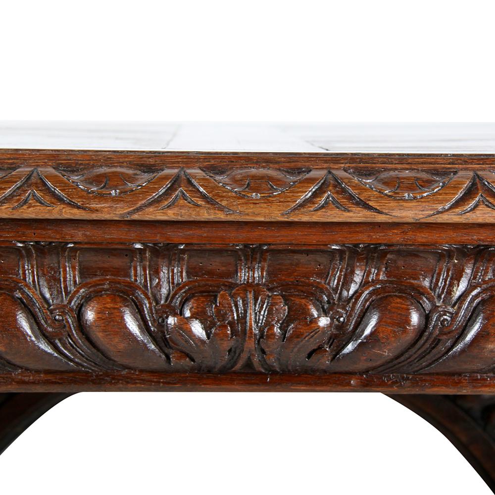 Impressive 19th century French carved oak Renaissance-Revival library table, the lavishly-carved pedestals united by a long stretcher with upper column arcade, the top with boldly-gadrooned apron, and fitted on one side with a large drawer.
 