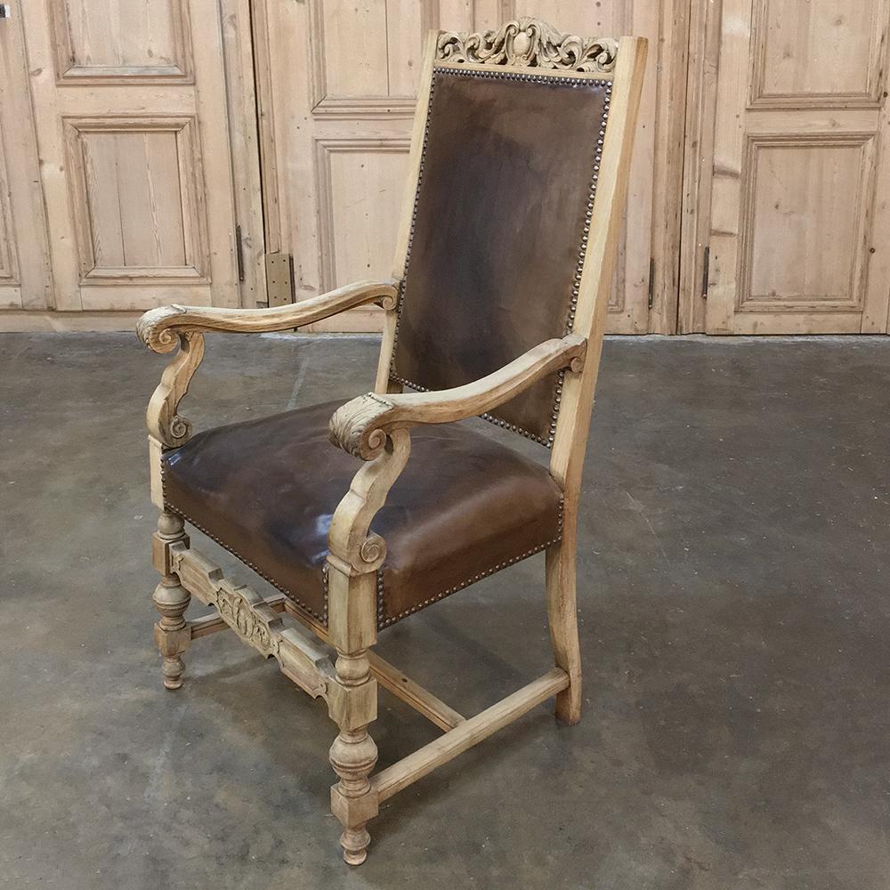 Ideal for the office, this handsome 19th century Renaissance Revival stripped oak armchair with original leather. Hand-carved from the seatback crown to the apron stretcher from solid white oak which has been left its natural color that has achieved