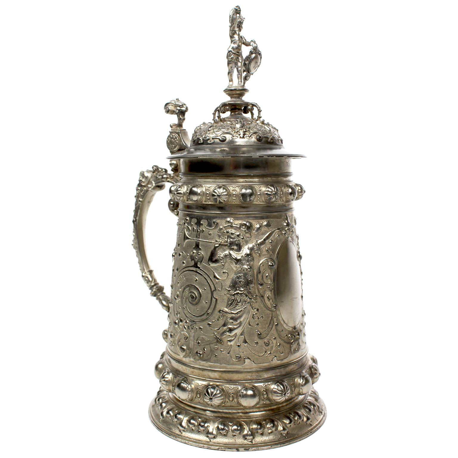 A Fine and Elaborate German 19th Century Renaissance Revival Style Britannia Silver Plated Beer-Tankard by The Württembergische Metallwarenfabrik (WMF). The tall ovoid mug engraved throughout with figures of maidens blowing trumpets, leaves, vines,