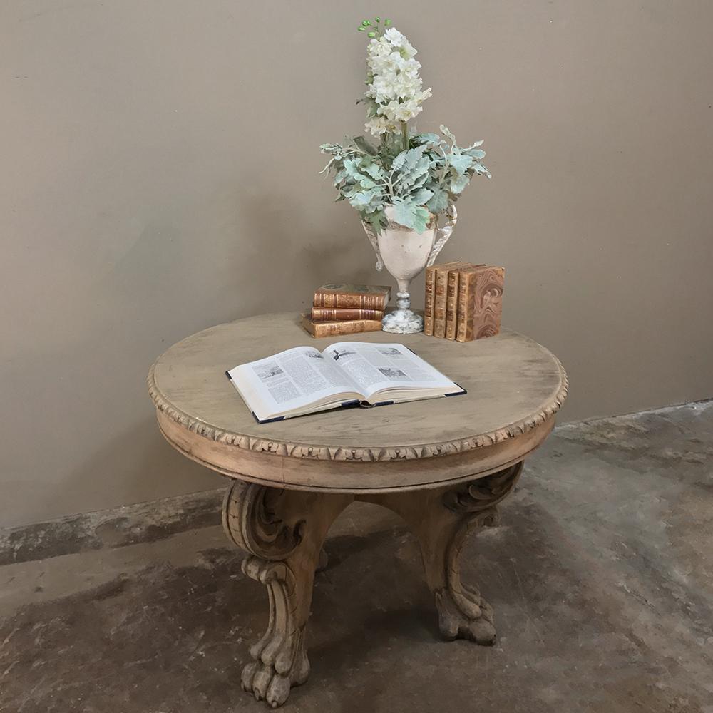This 19th century Renaissance Revival stripped oak center table is complete with expertly scrolled and carved legs and is supported by lion's paw feet, and constructed entirely from European oak to last for centuries! Ideal as a tall coffee table,