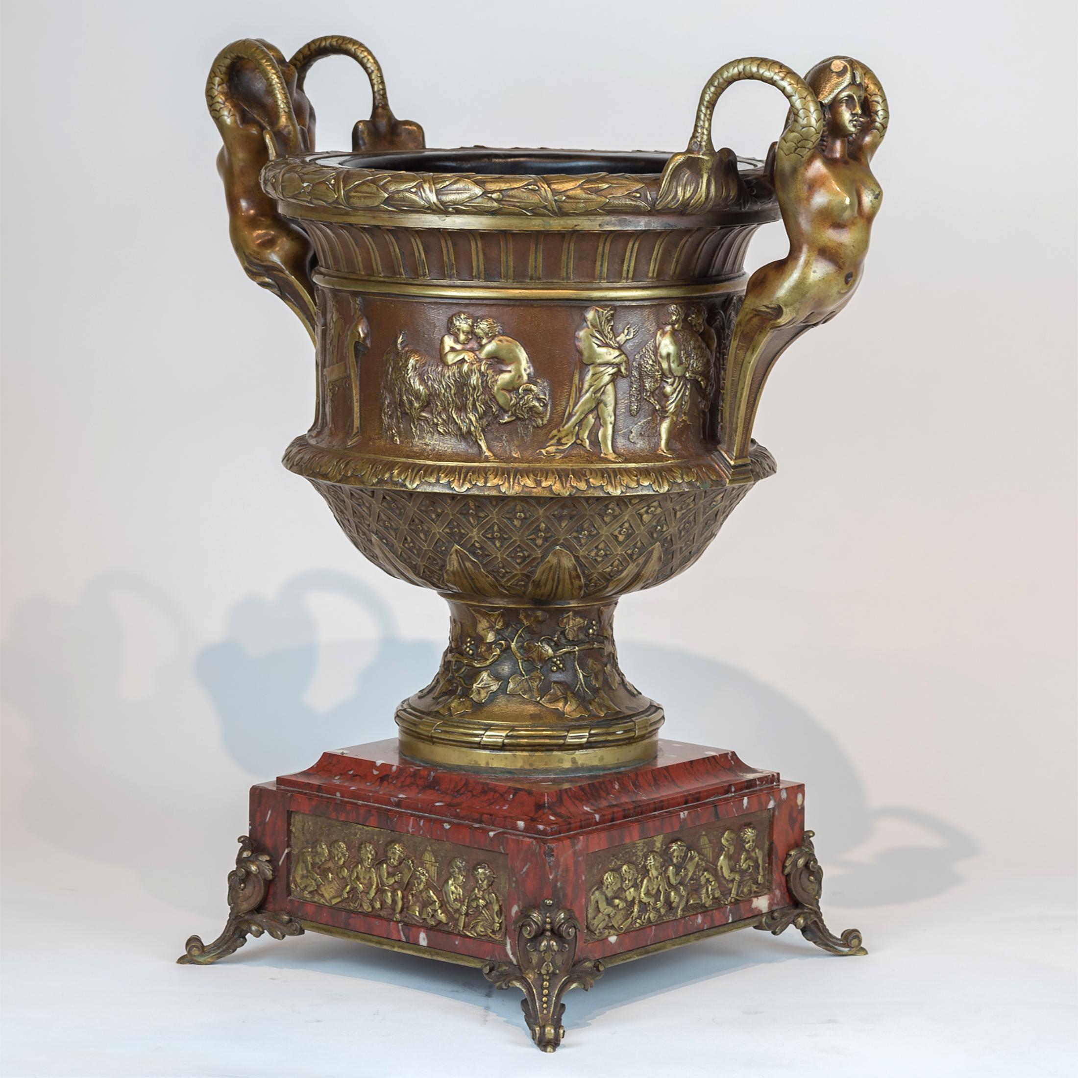 A very fine quality Renaissance-style bronze centrepiece vase with Mermaid handles surmounted on a square rouge marble. Finely casted with acanthus leaf and allegorical scene. 

Origin: French
Date: 19th century
Dimension: 18 3/4 in x 16 1/2 in.