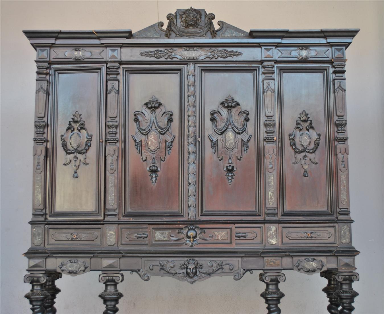 Chateau furniture: Important blackened wooden cabinet in Renaissance style with twisted columns. Richly carved. Decor with heads of women and lion. French cabinetmaker work, 19th century. Very good quality of production. Inlay in green marble